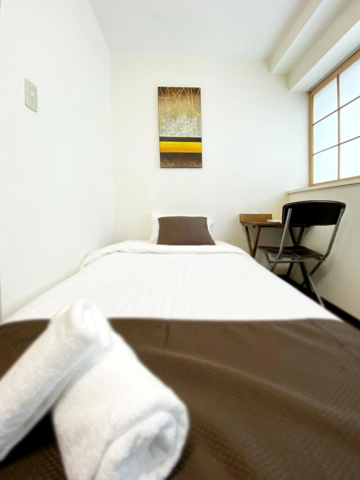 Bed in OUCHI HOTEL Yokogawa