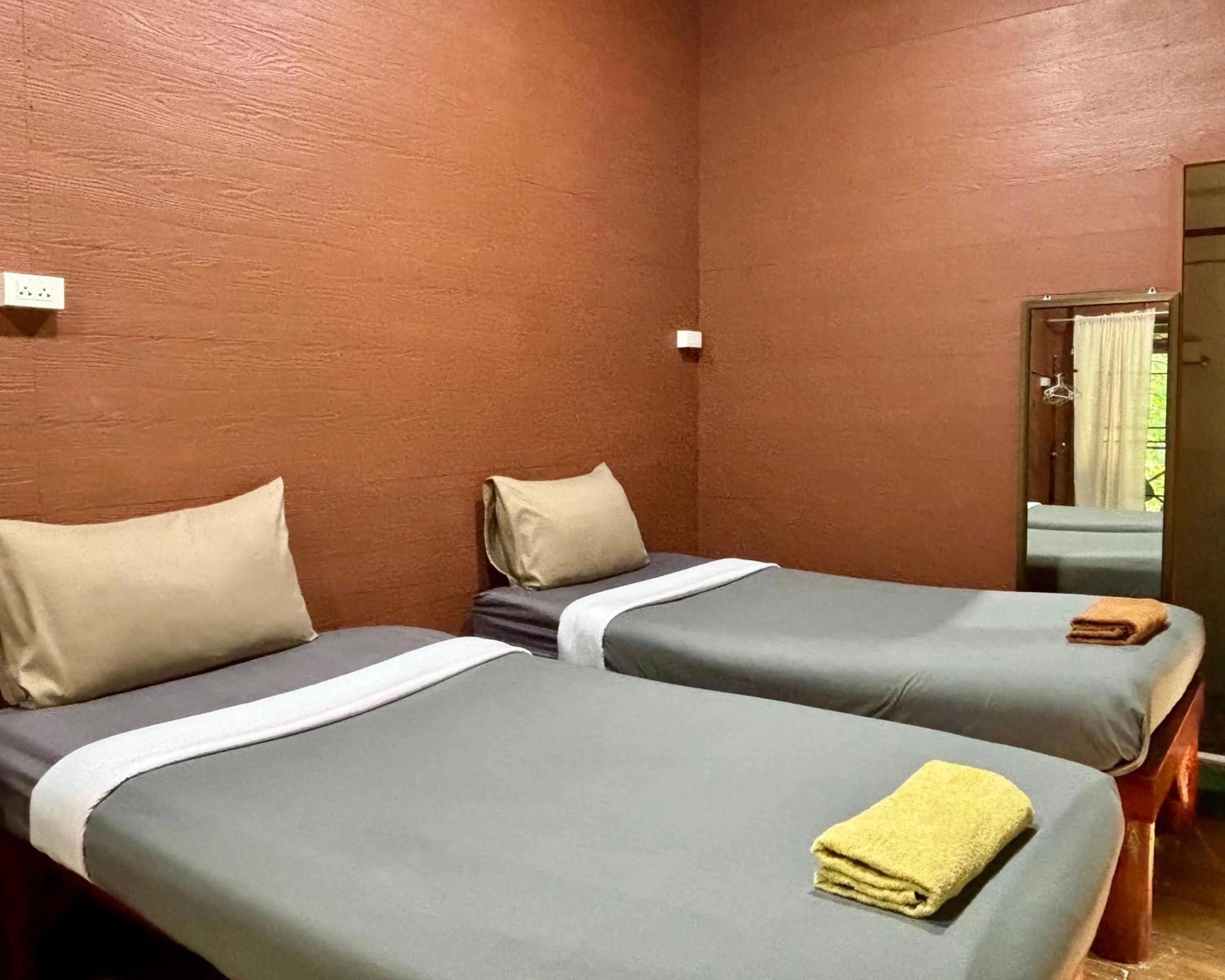 Bed in Maewin Guesthouse and Resort