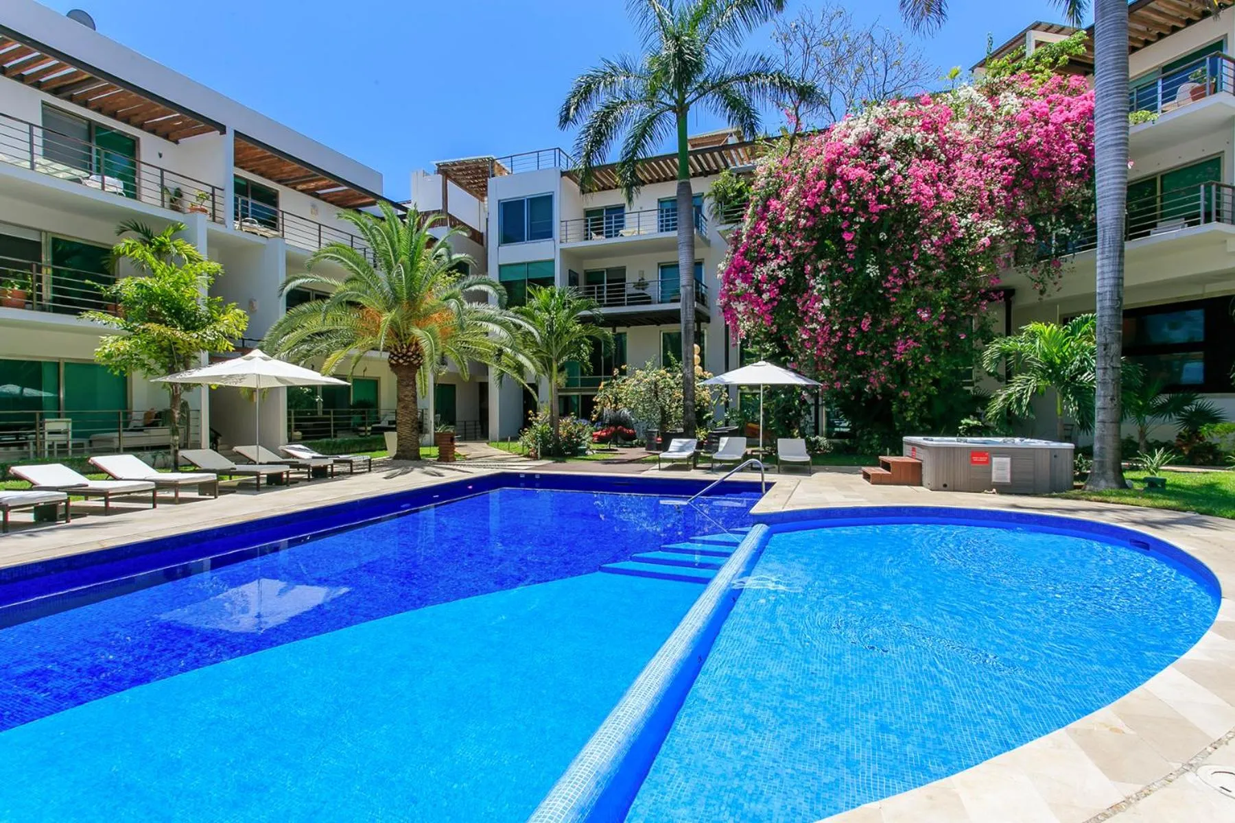 Property building in 3-Level Condo with a Private Balcony & Rooftop Lounge