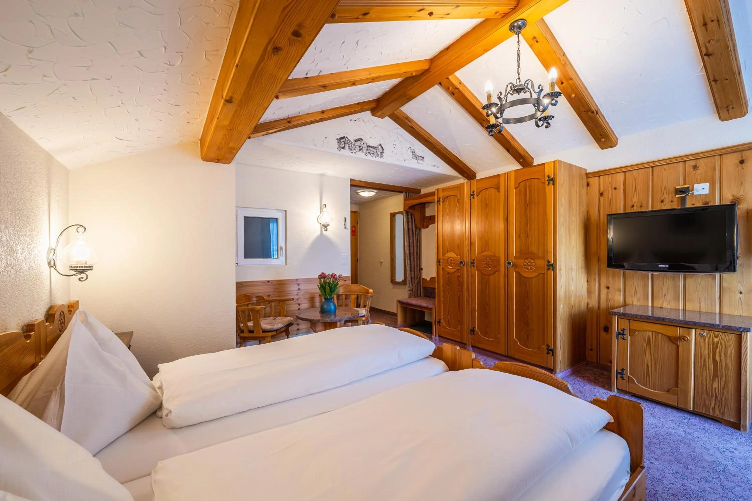 Bed in Hotel Christiania Saas-Fee