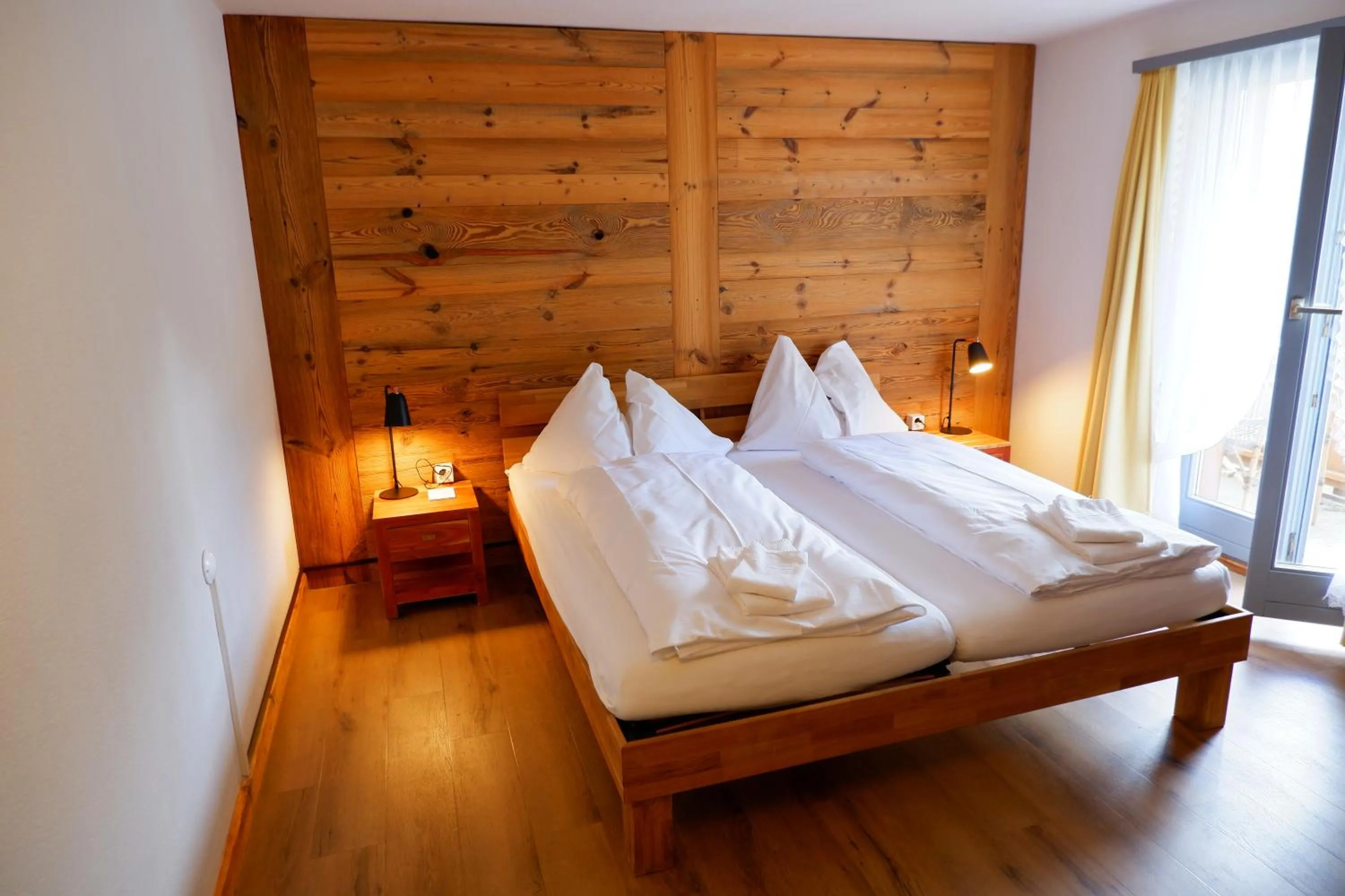 Bed in Hotel Christiania Saas-Fee