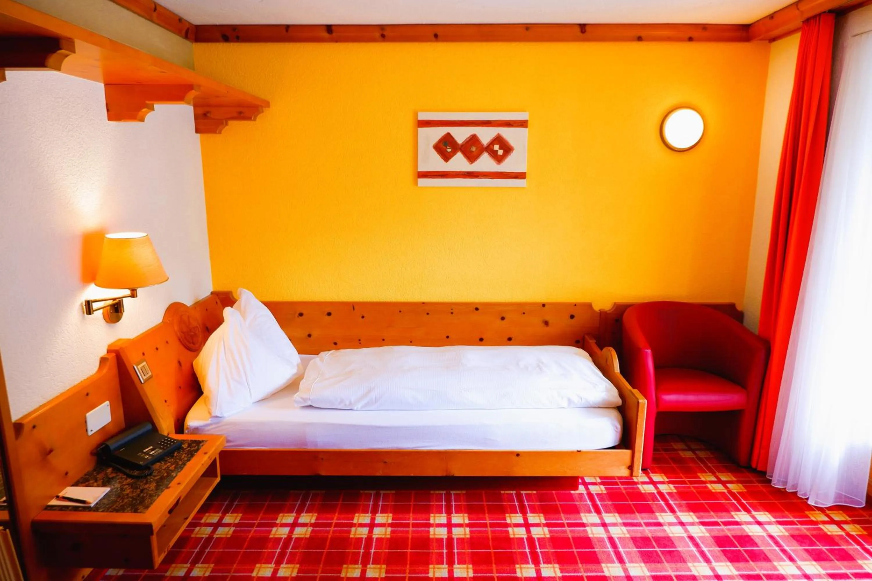 Bed in Hotel Christiania Saas-Fee