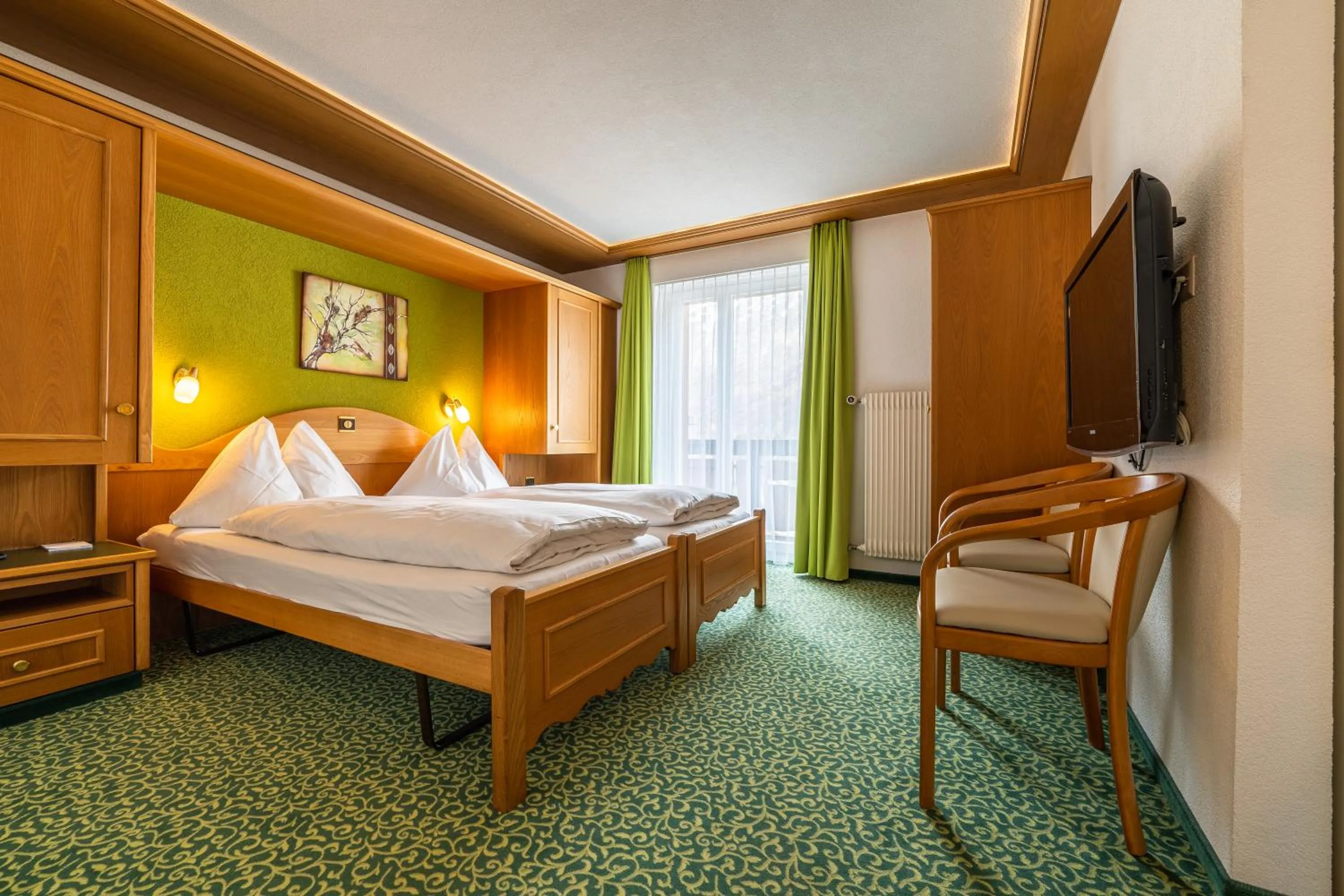 Bed in Hotel Christiania Saas-Fee