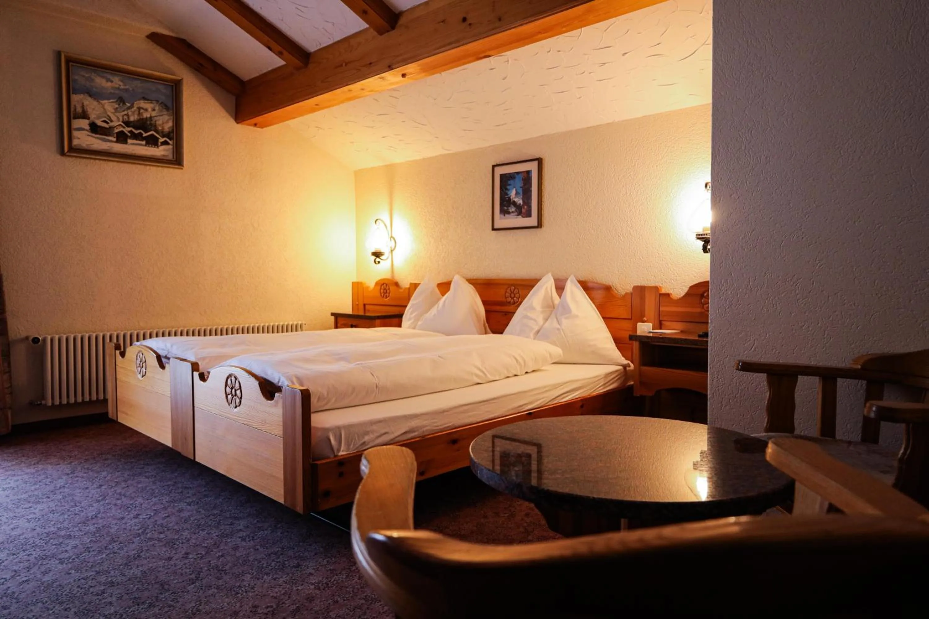 Bed in Hotel Christiania Saas-Fee