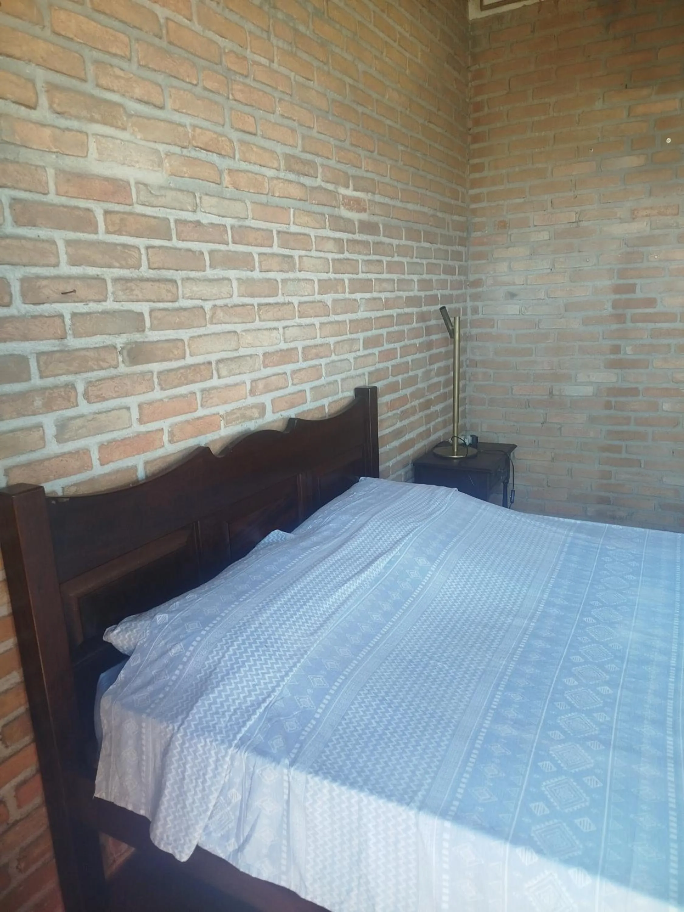 Bed in Chalé de Pedra - Hospedaria