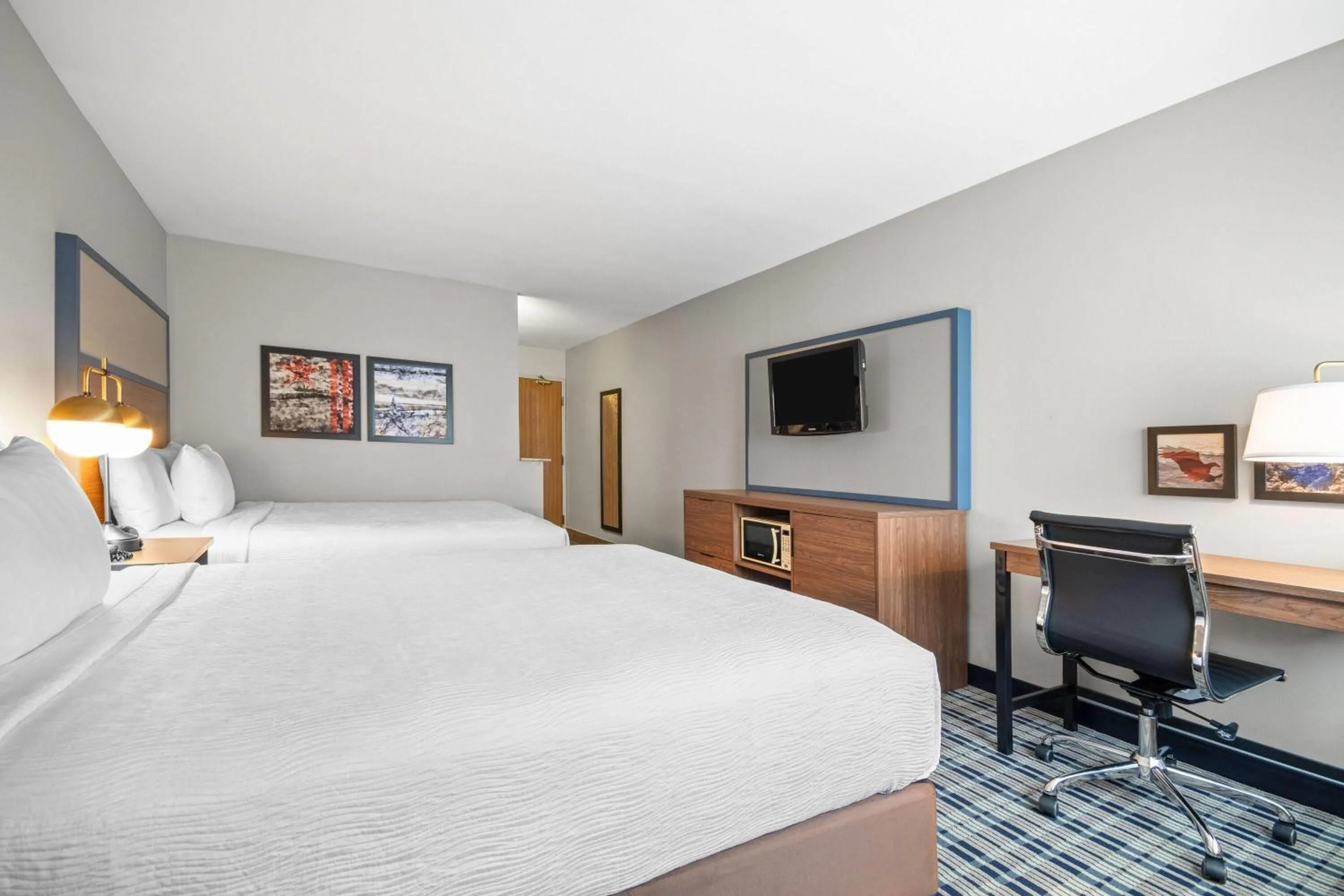 Bed in AmericInn by Wyndham Beloit