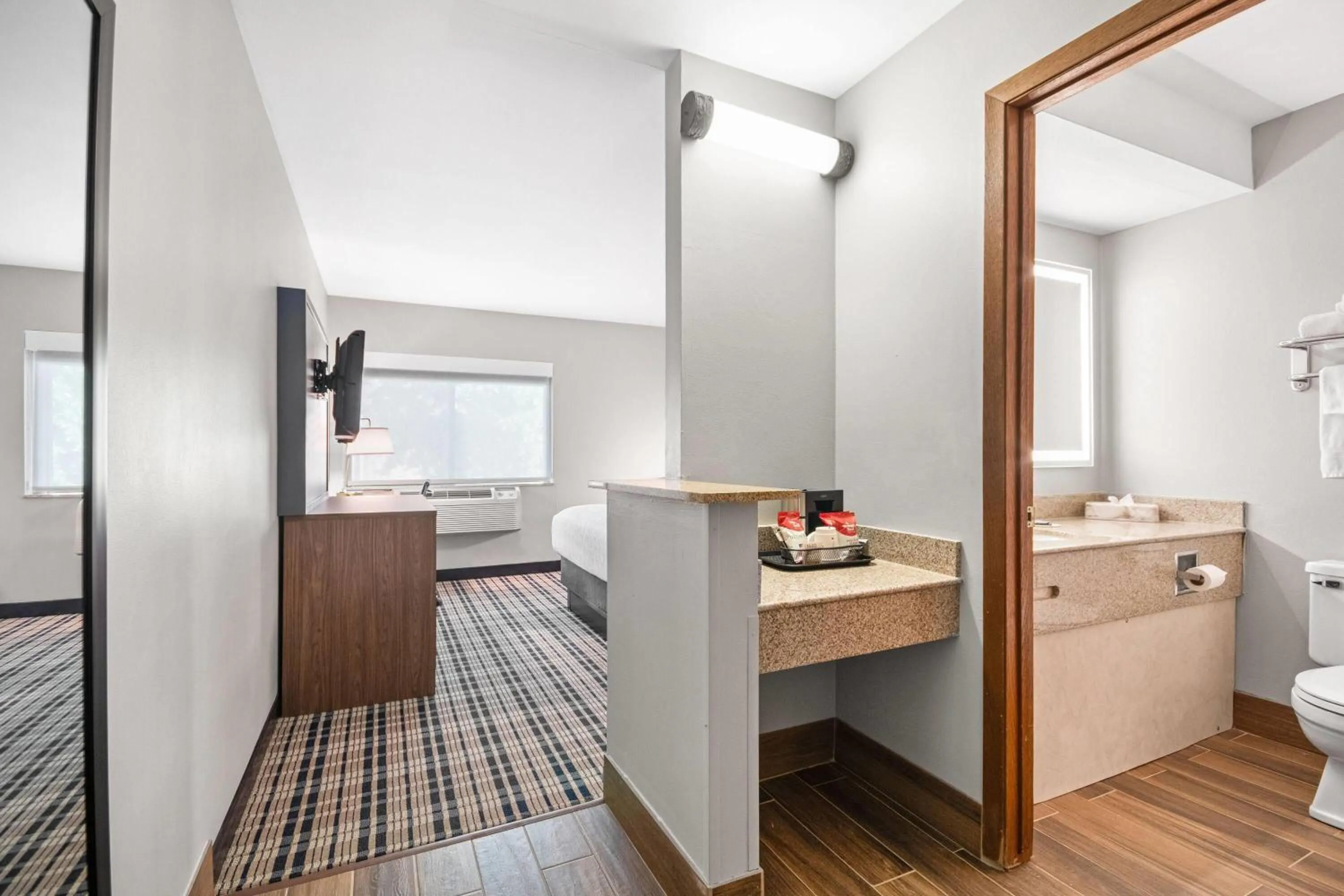 Bed in AmericInn by Wyndham Beloit