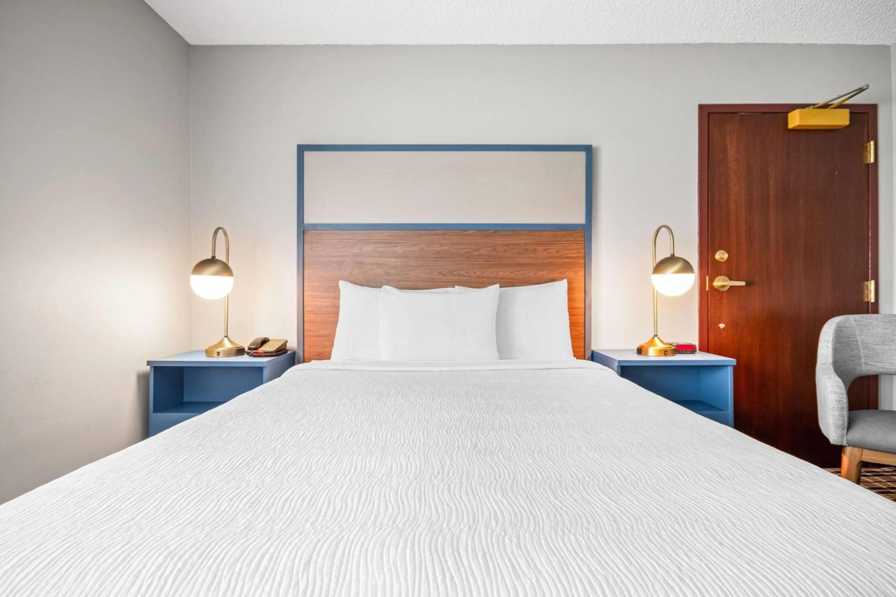 Bed in AmericInn by Wyndham Beloit