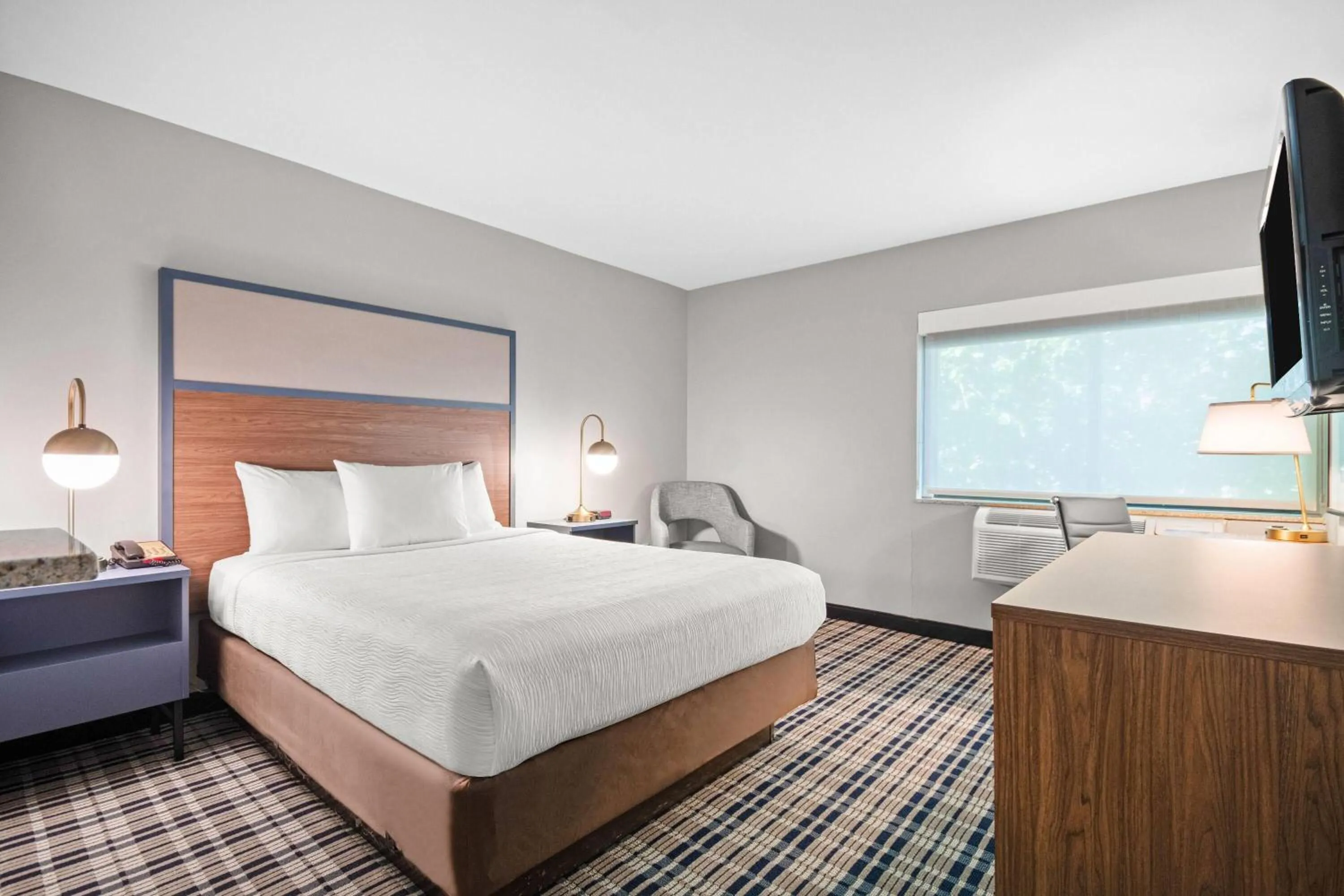 Bed in AmericInn by Wyndham Beloit