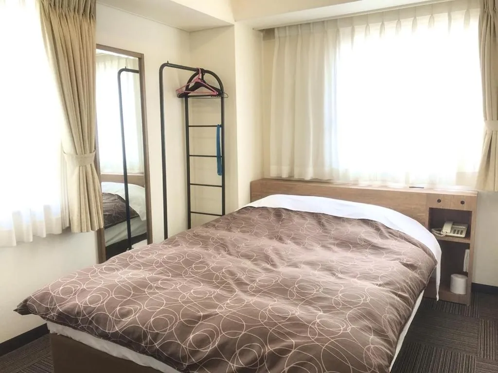 Bed in Ichinomiya Green Hotel