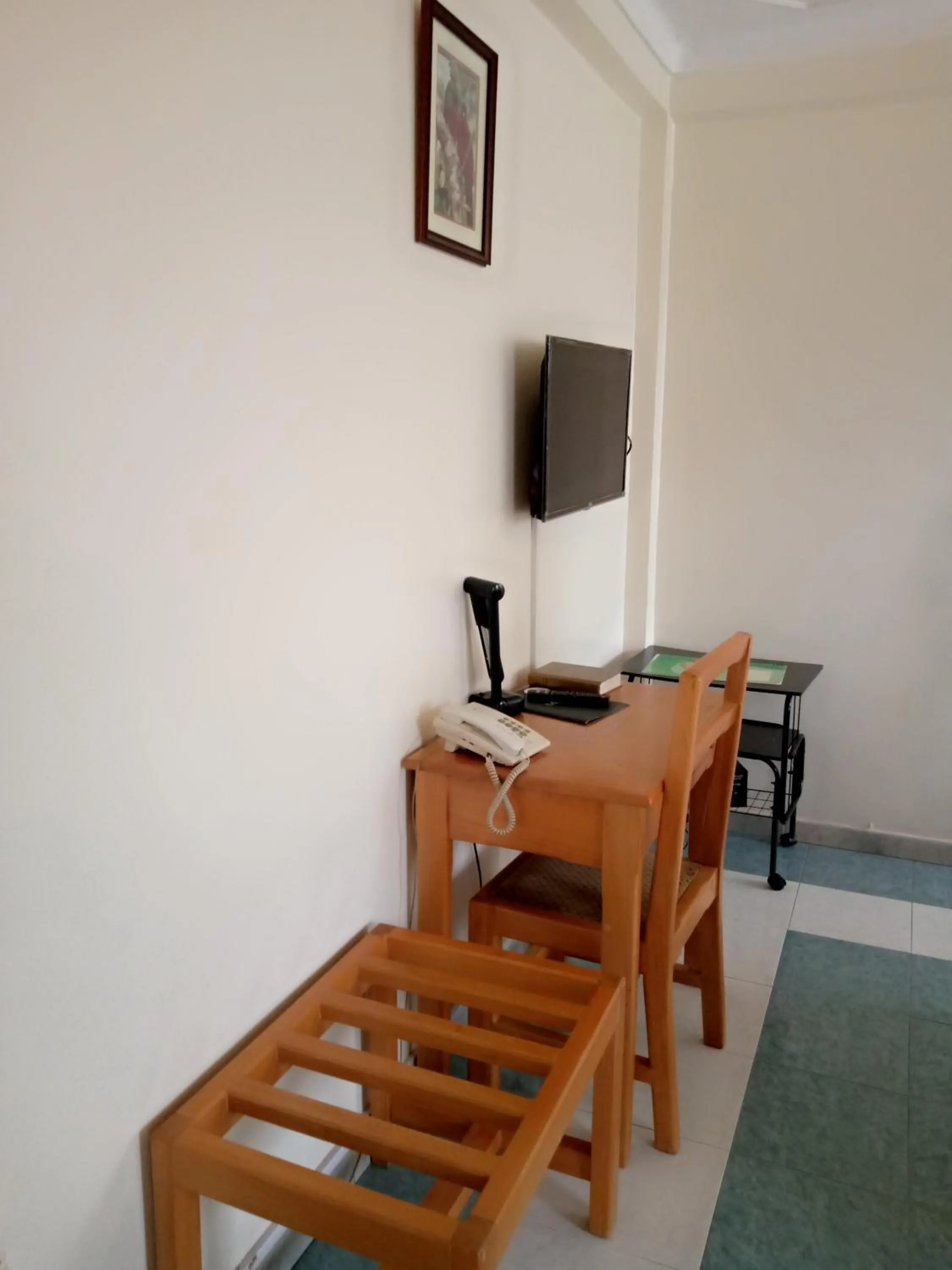 Communal lounge/ TV room in Palm Springs Hotel Masaka