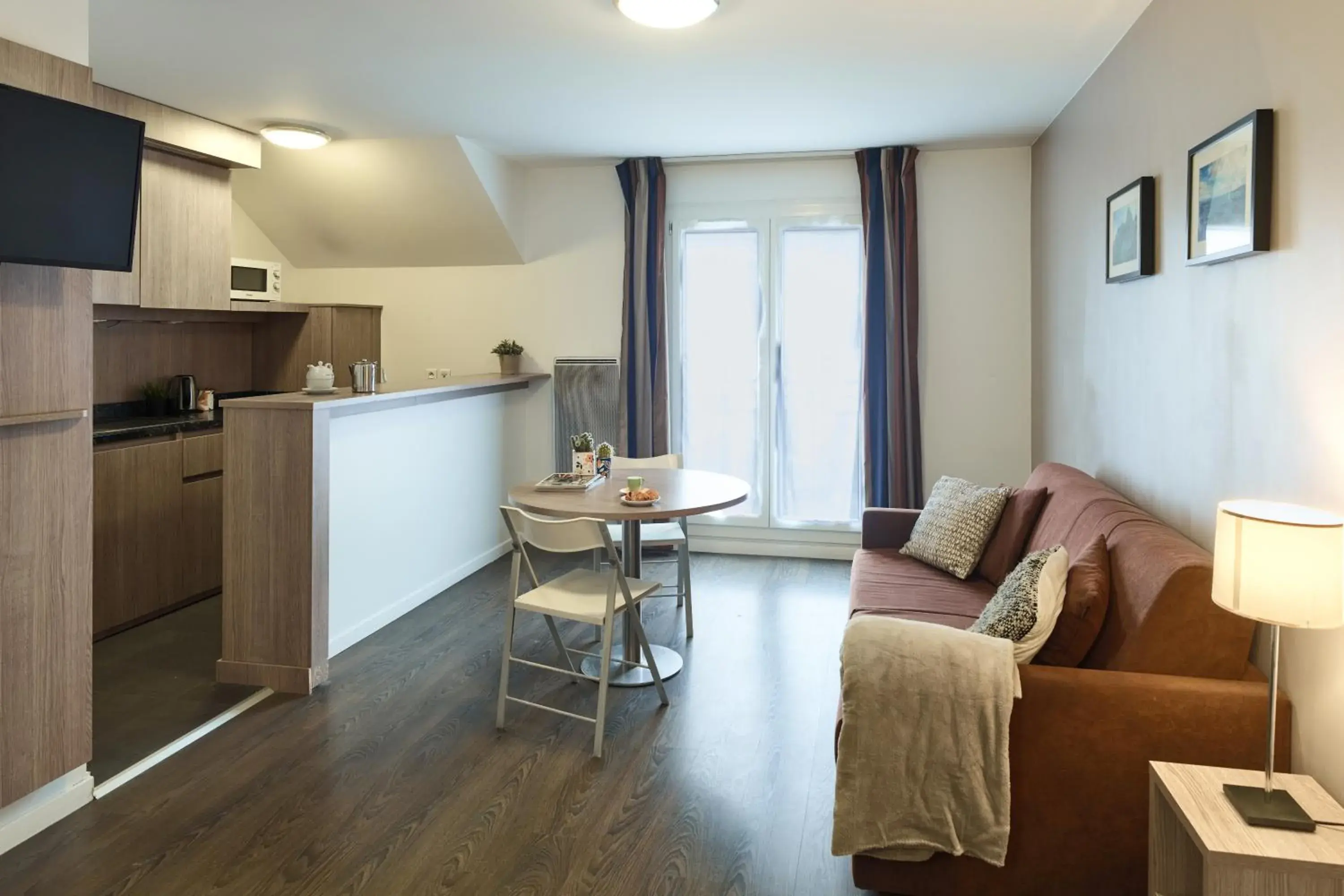 Living room in Zenitude Hôtel Résidences Roissy Village Living room in Zenitude Hôtel Résidences Roissy Village