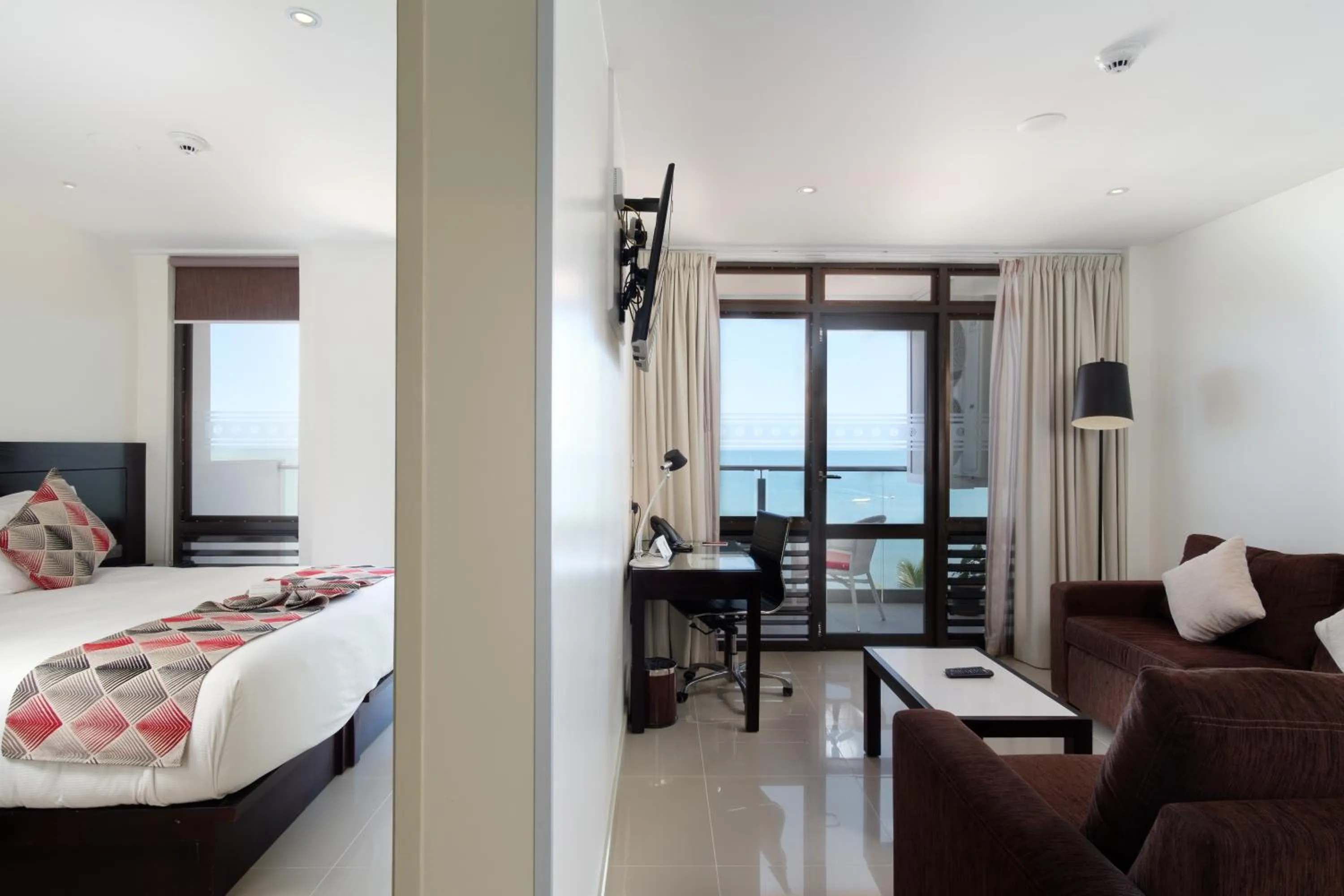 Living room, Bed in Ramada Suites by Wyndham Wailoaloa Beach Fiji