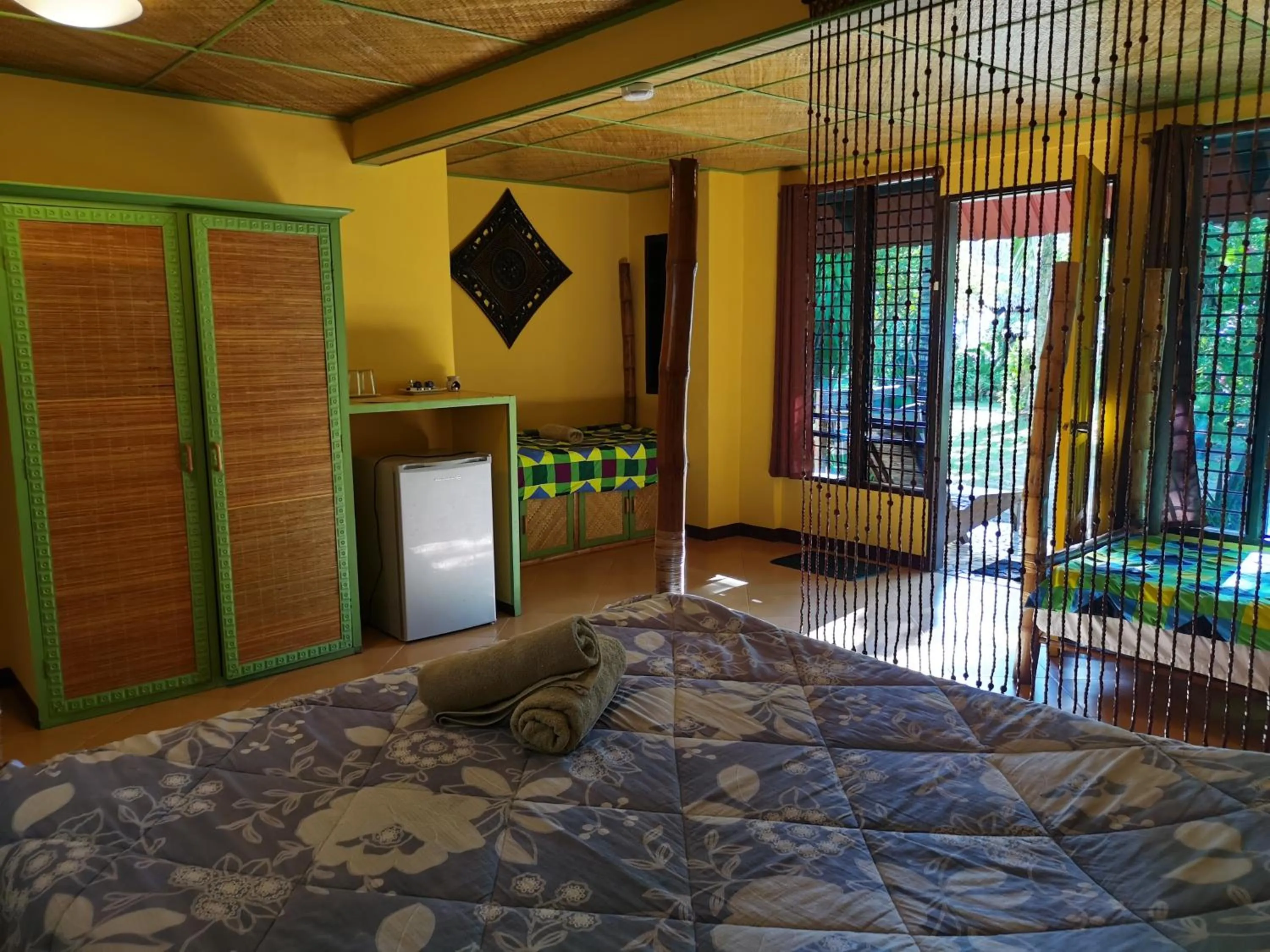 Bed in Ravenala Beach Bungalows