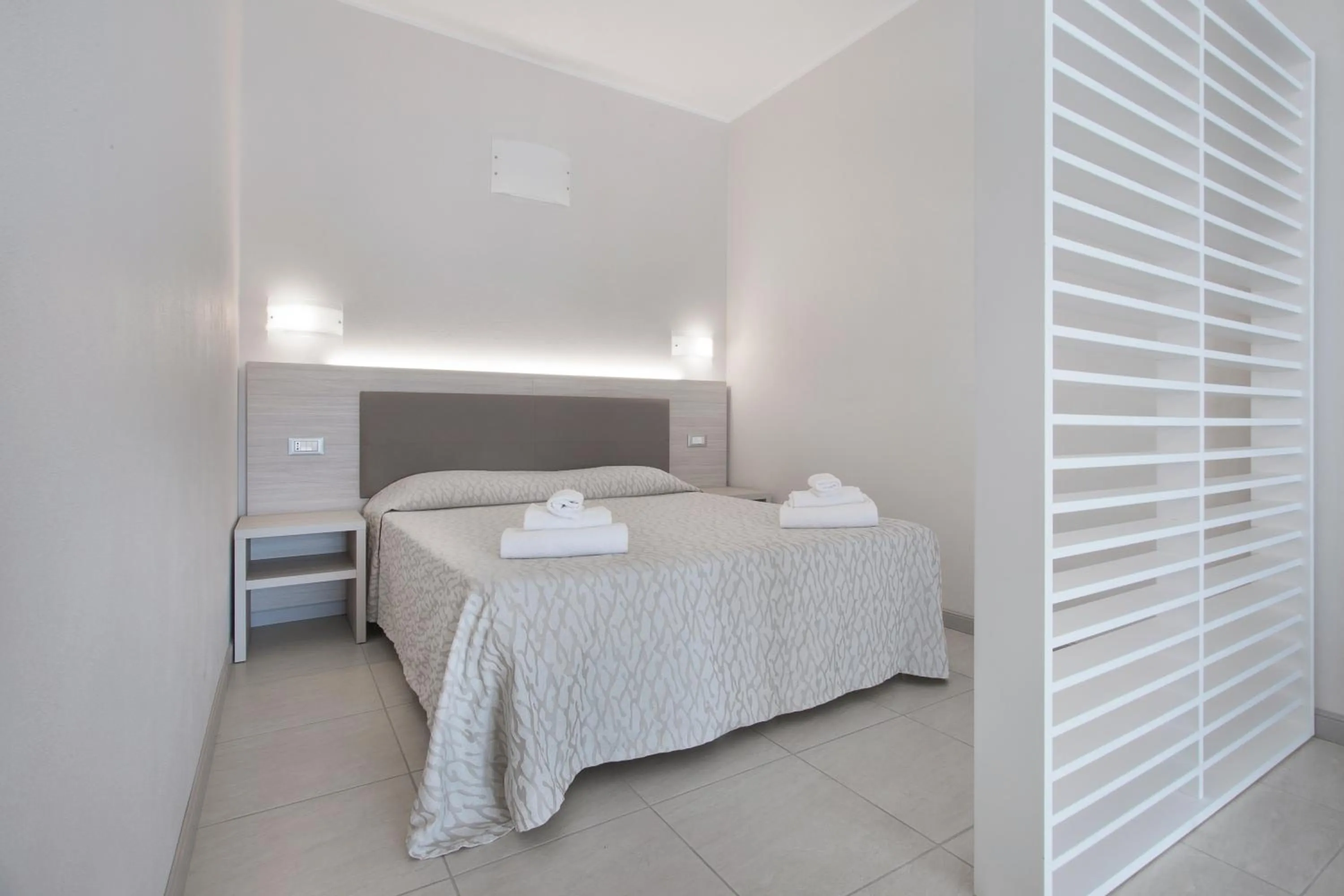 Bed in Diano Sporting Apartments