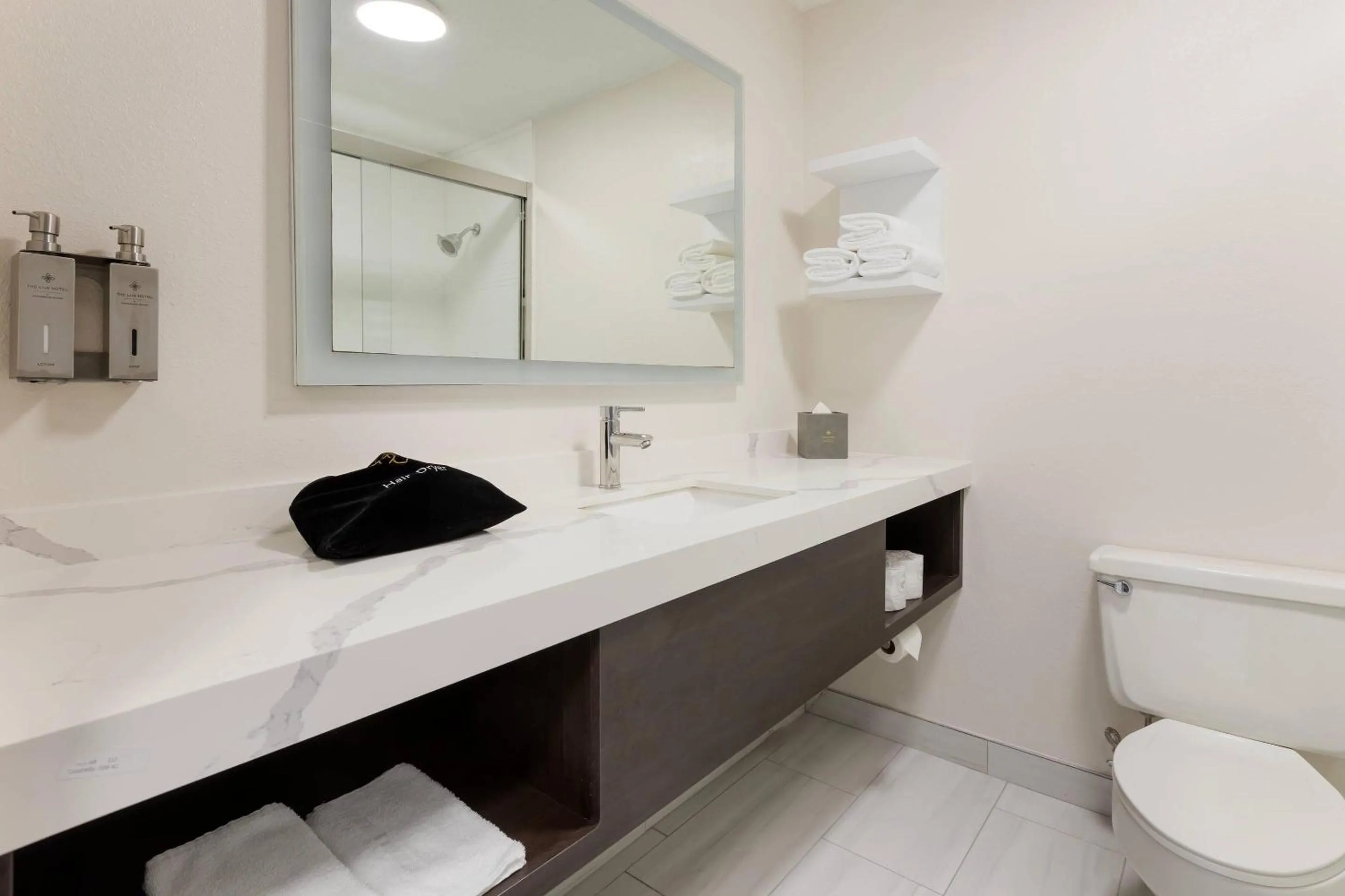 Bedroom in The Lux Hotel & Conference Center, an Ascend Collection Hotel