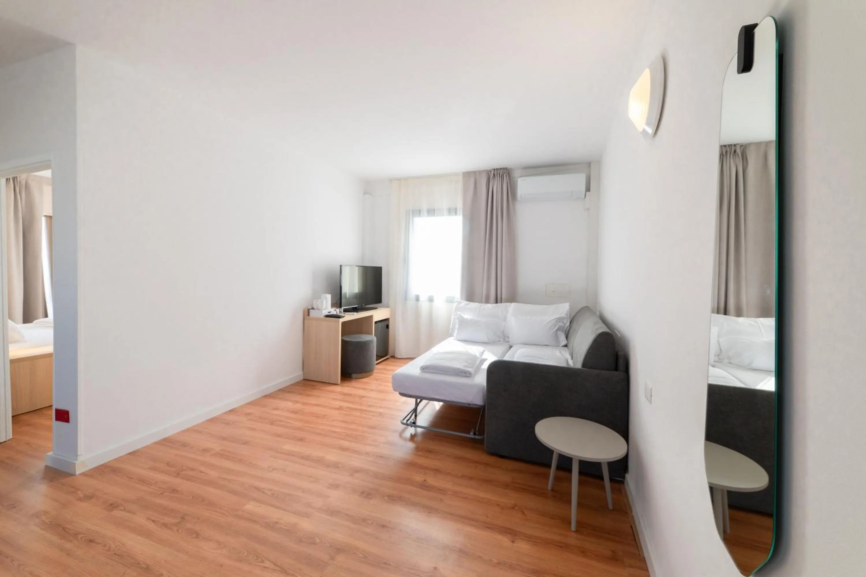 Living room, Bed in Hi Hotels Riva del Garda