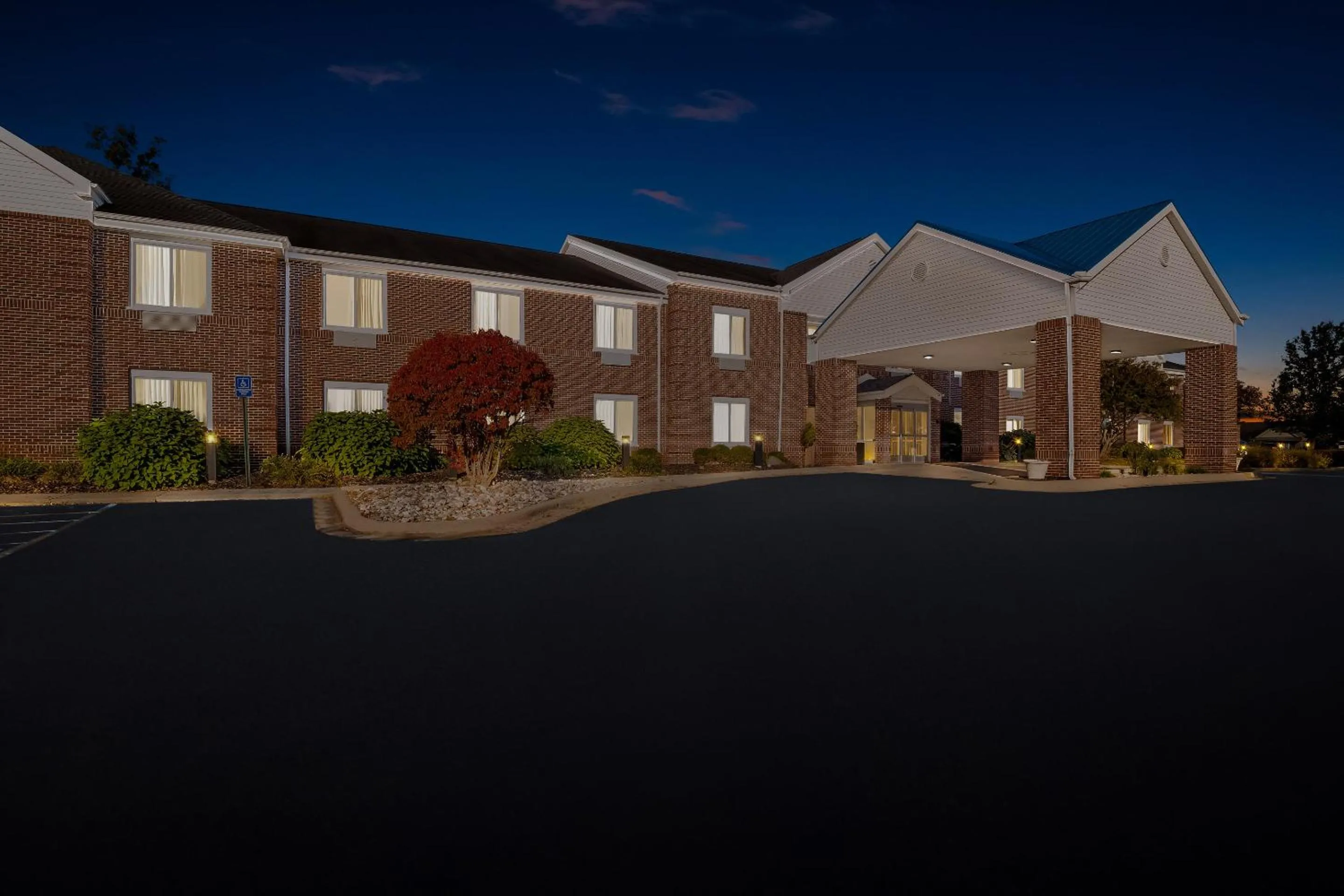 Property building in HomeTowne Studios by Red Roof East Lansing - Okemos