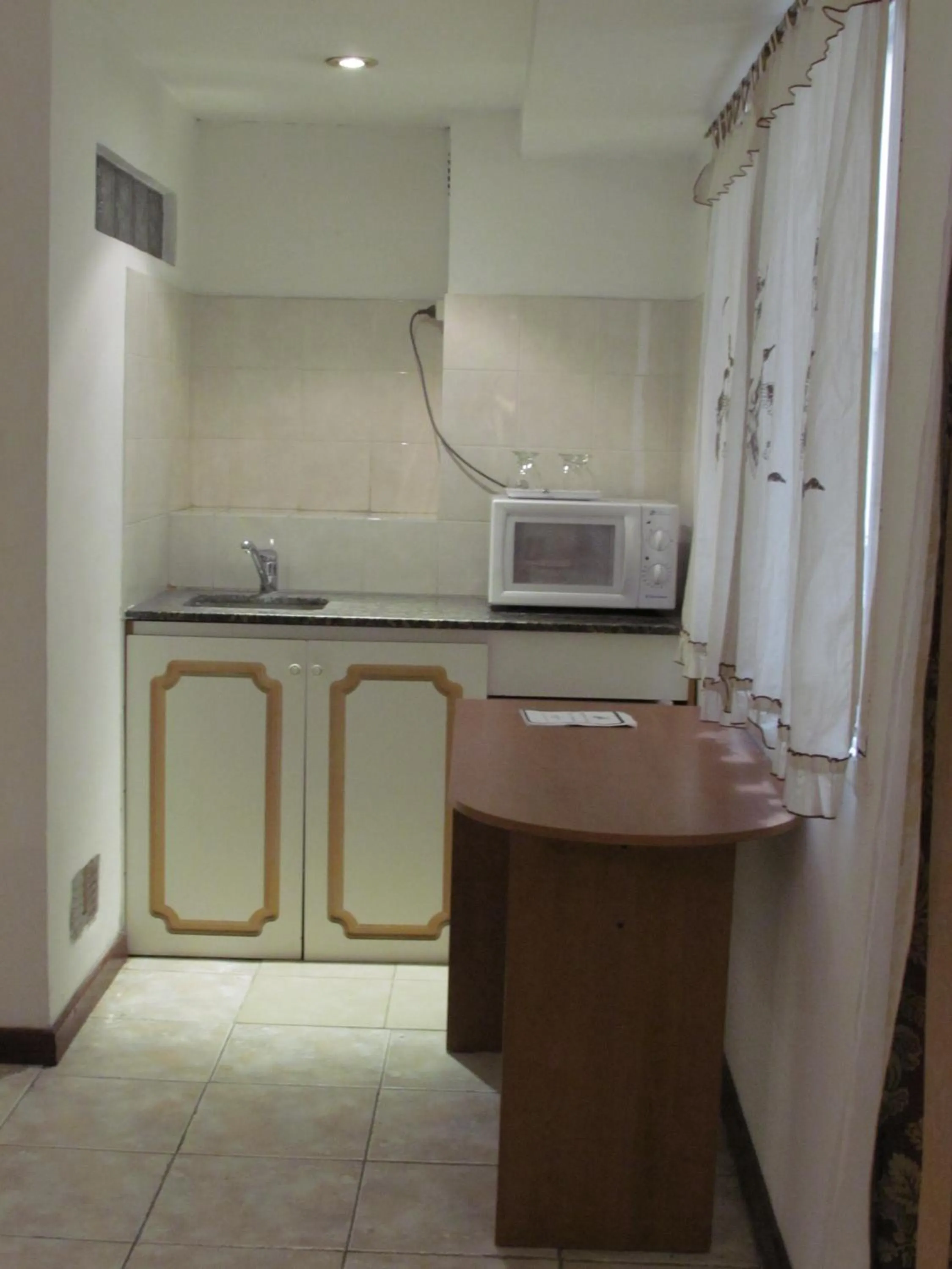 Kitchen or kitchenette in San Remo Grand Hotel