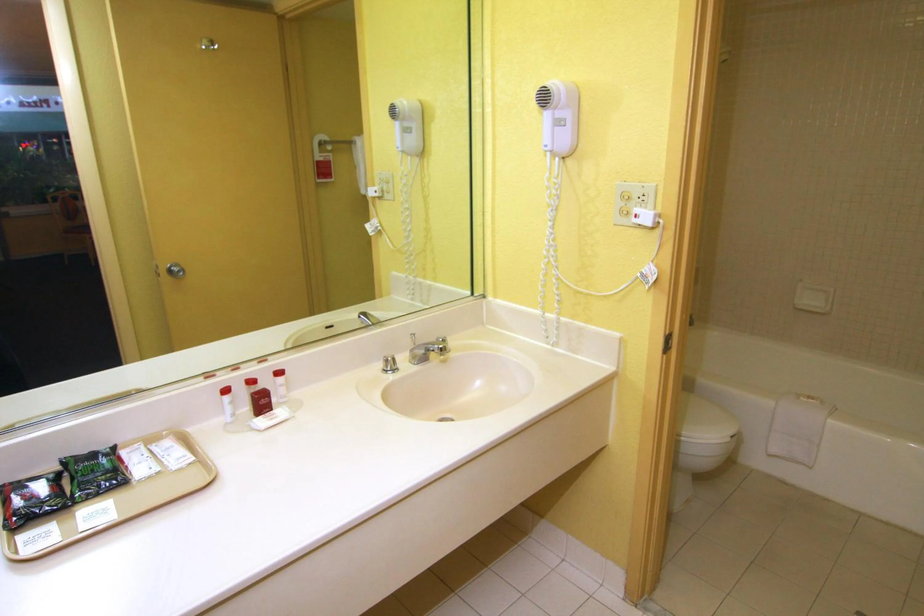Bathroom in Ramada by Wyndham Kissimmee Gateway - Free Theme Park Shuttle