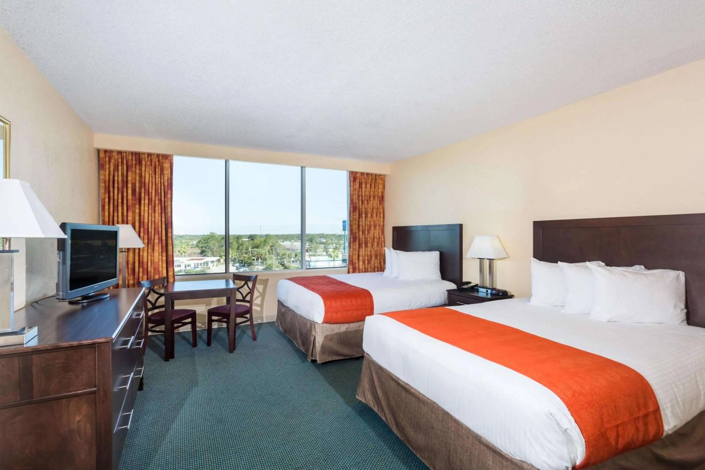Photo of the whole room, Bed in Ramada by Wyndham Kissimmee Gateway - Free Theme Park Shuttle