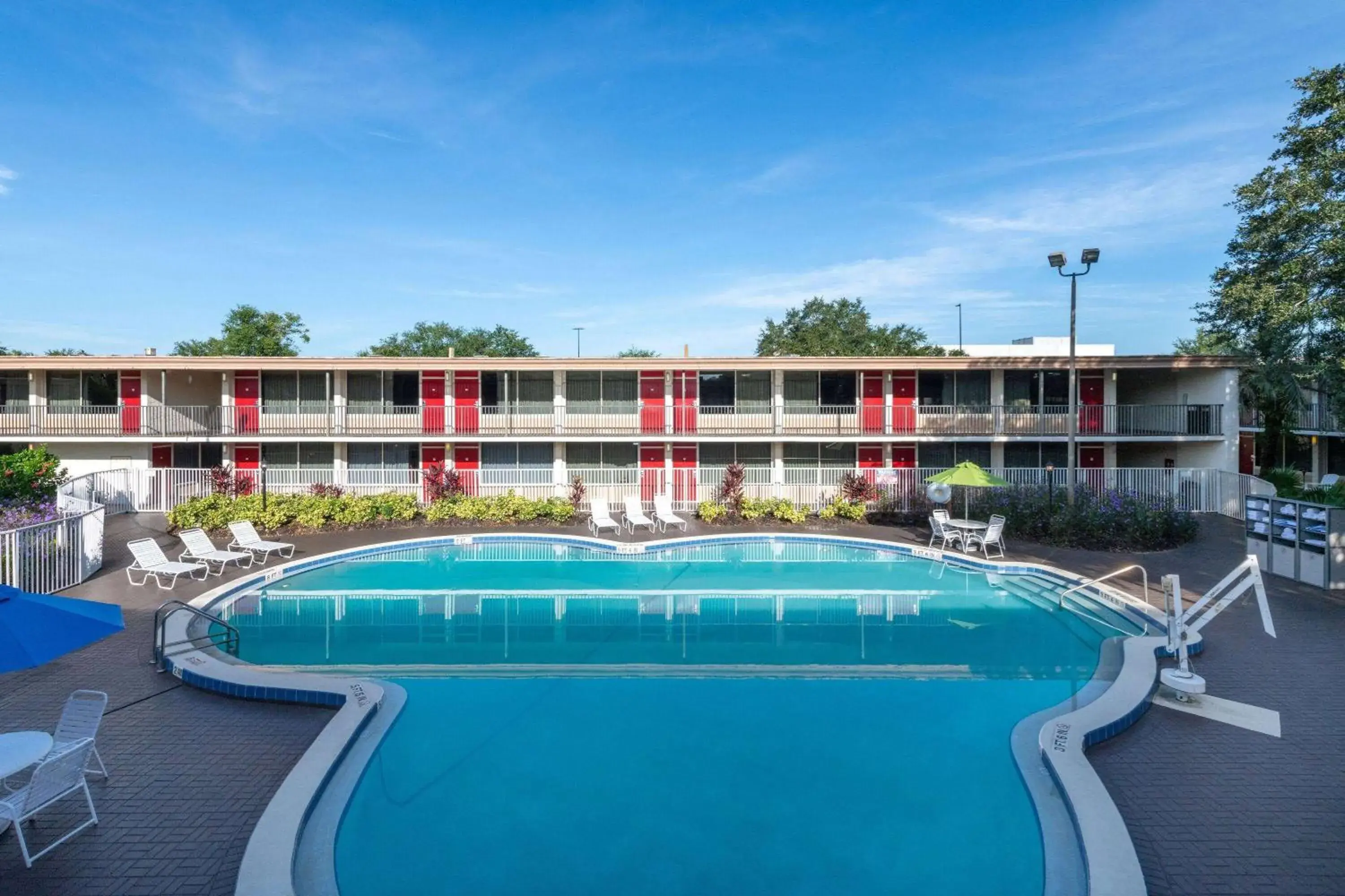 Pool view in Ramada by Wyndham Kissimmee Gateway - Free Theme Park Shuttle Pool view in Ramada by Wyndham Kissimmee Gateway - Free Theme Park Shuttle