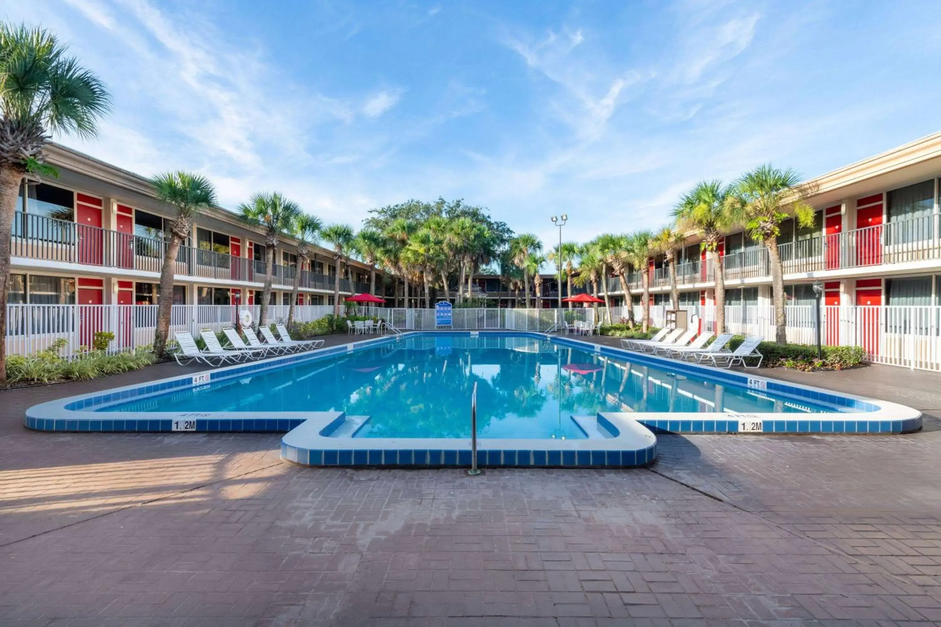 Pool view in Ramada by Wyndham Kissimmee Gateway - Free Theme Park Shuttle Pool view in Ramada by Wyndham Kissimmee Gateway - Free Theme Park Shuttle