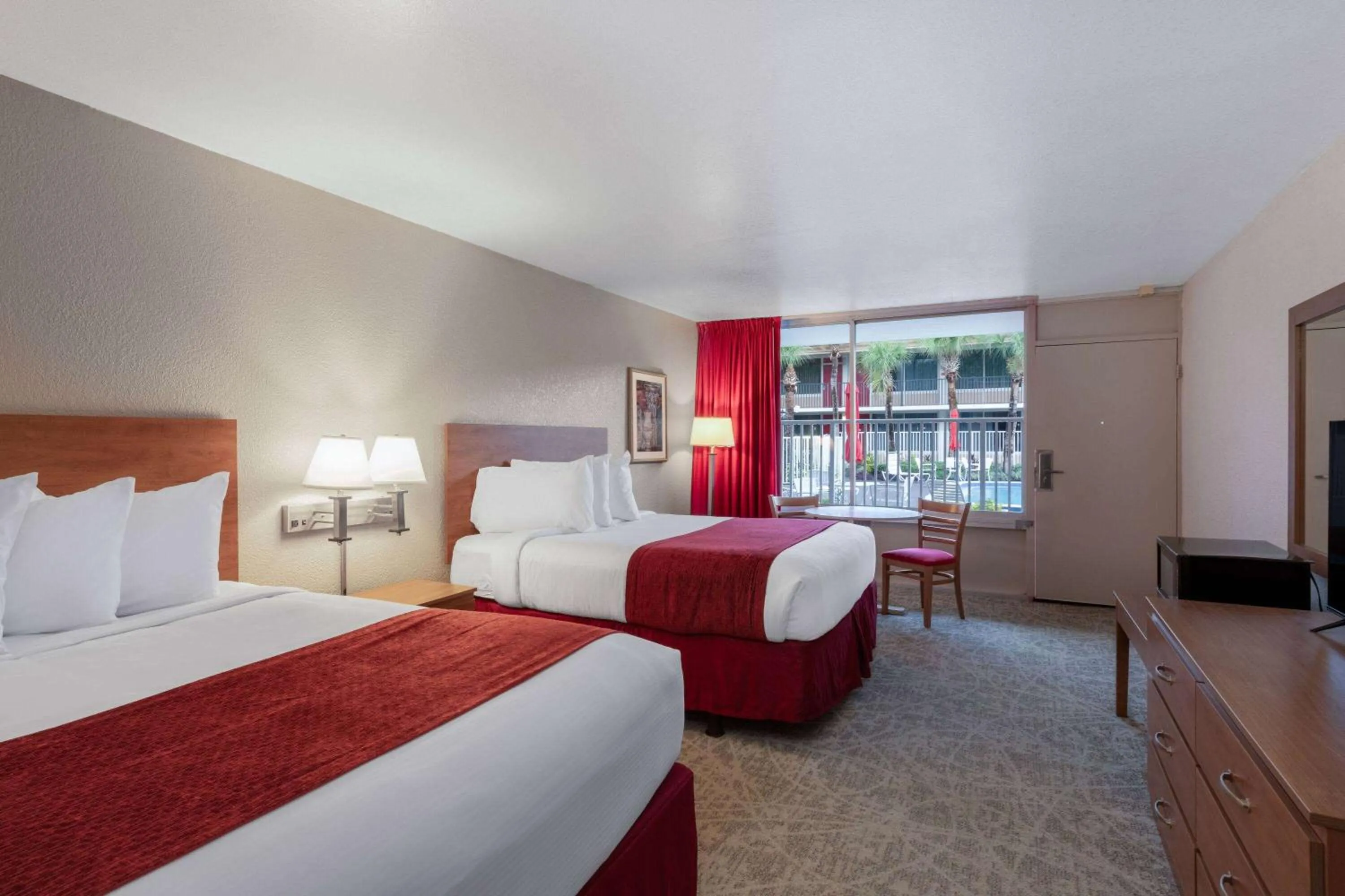 Photo of the whole room, Bed in Ramada by Wyndham Kissimmee Gateway - Free Theme Park Shuttle
