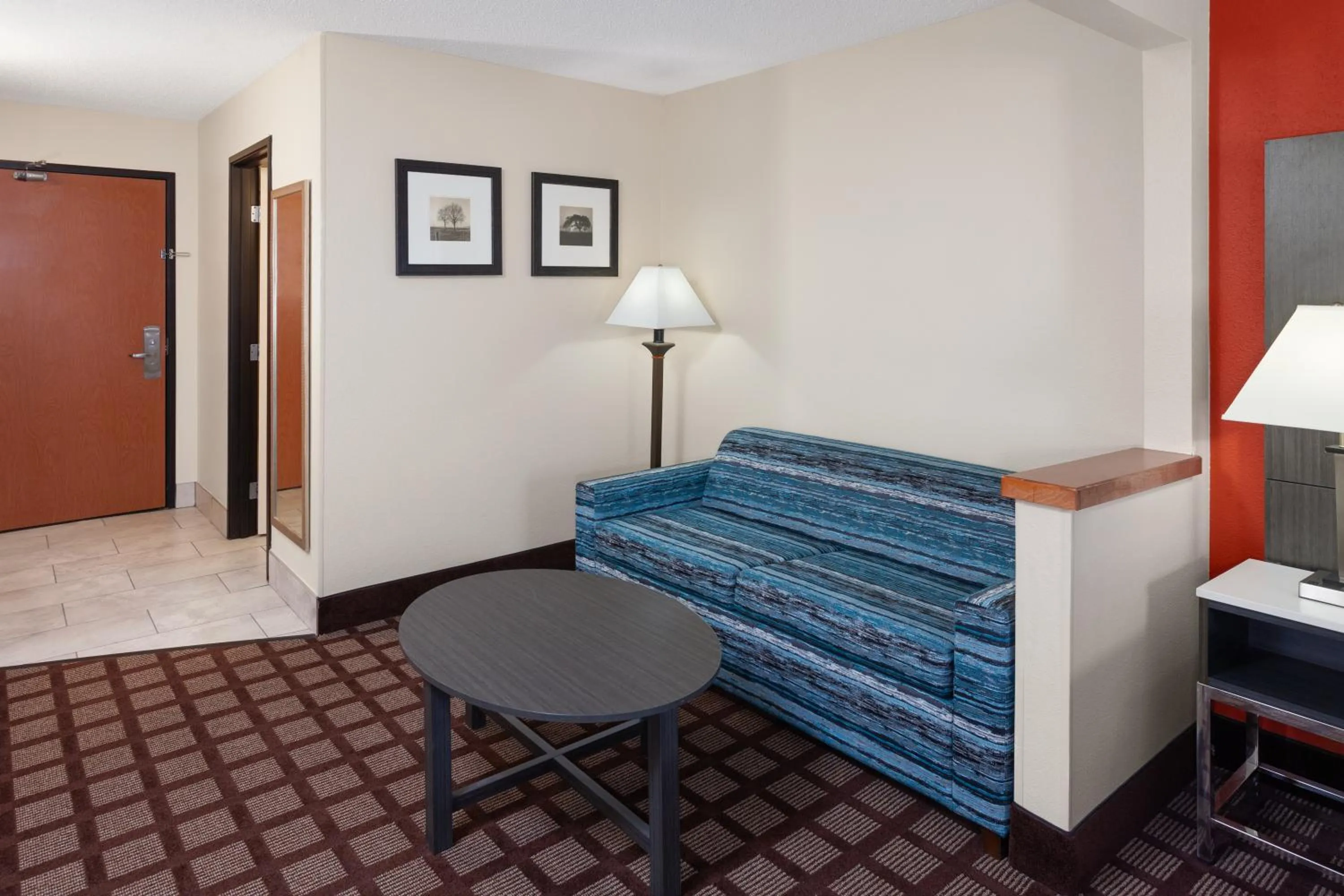 Seating area, Bed in AmericInn by Wyndham Hudson