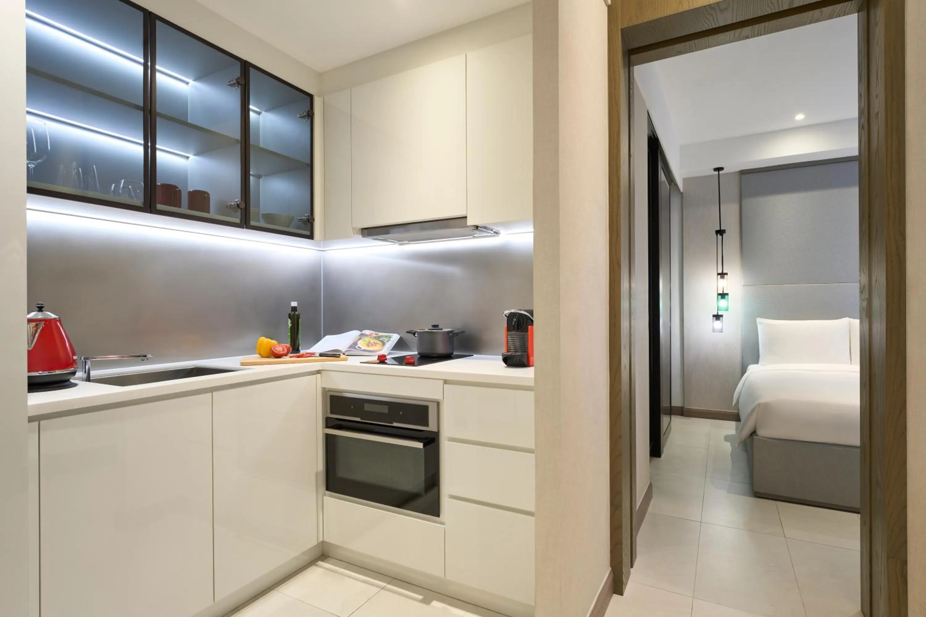 Kitchen or kitchenette, Bed in Oakwood Studios Singapore