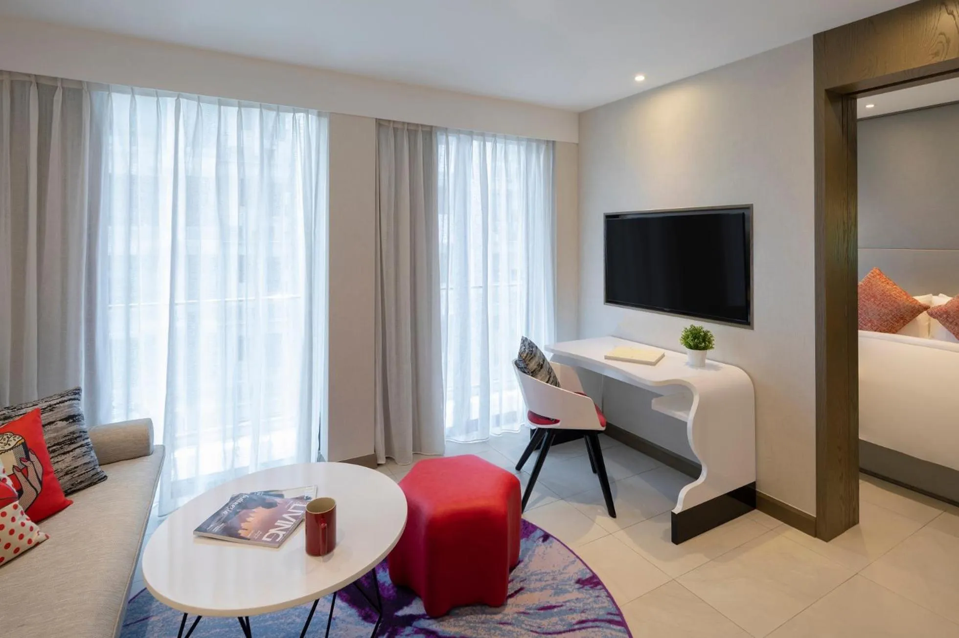 Living room, Bed in Oakwood Studios Singapore