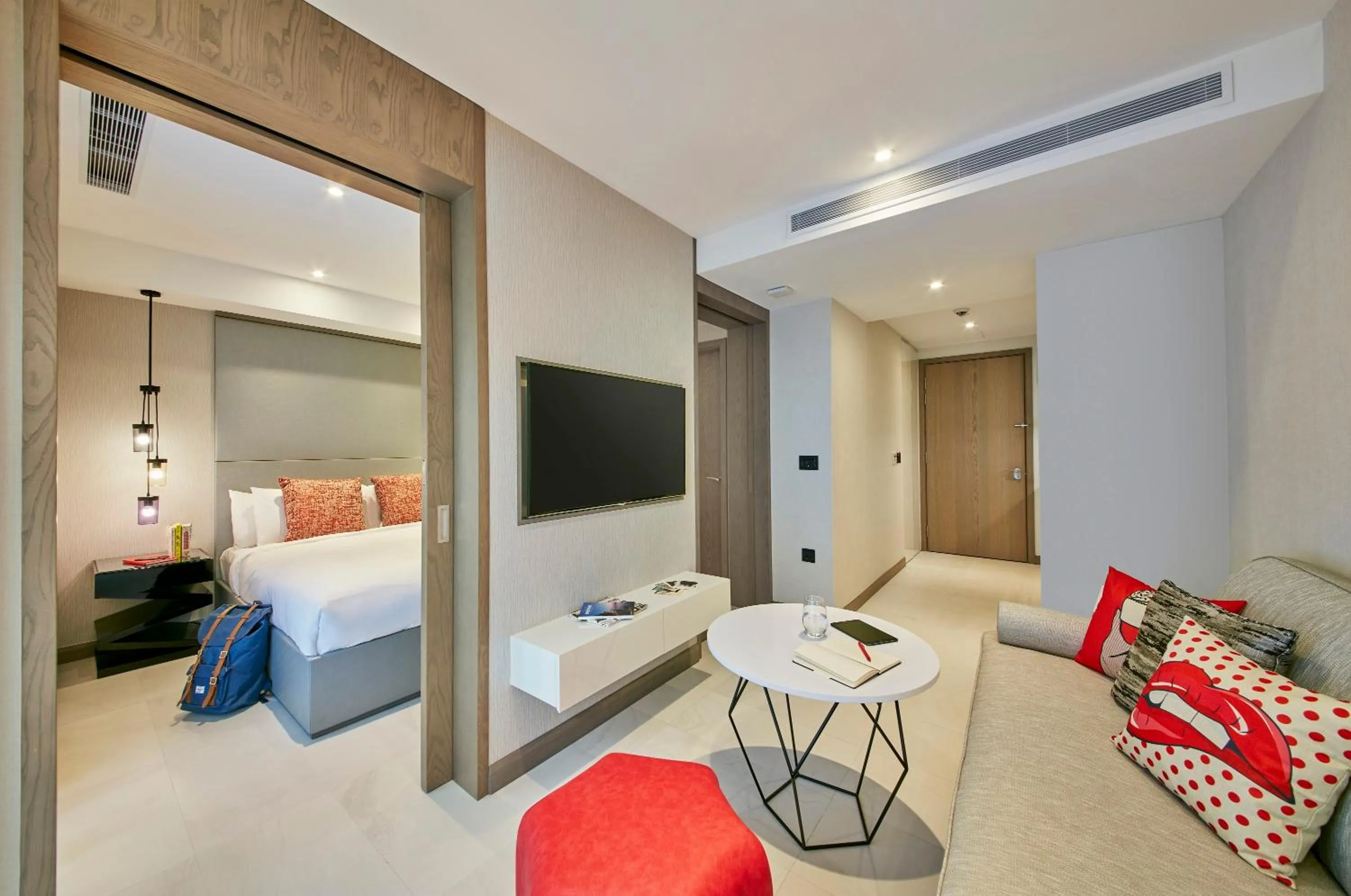 Communal lounge/ TV room, Bed in Oakwood Studios Singapore
