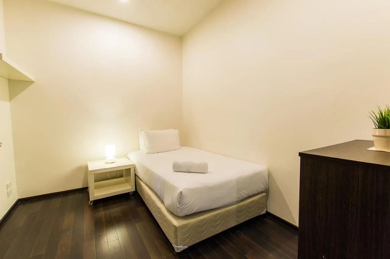 Bed in The Title Comfort Condotel