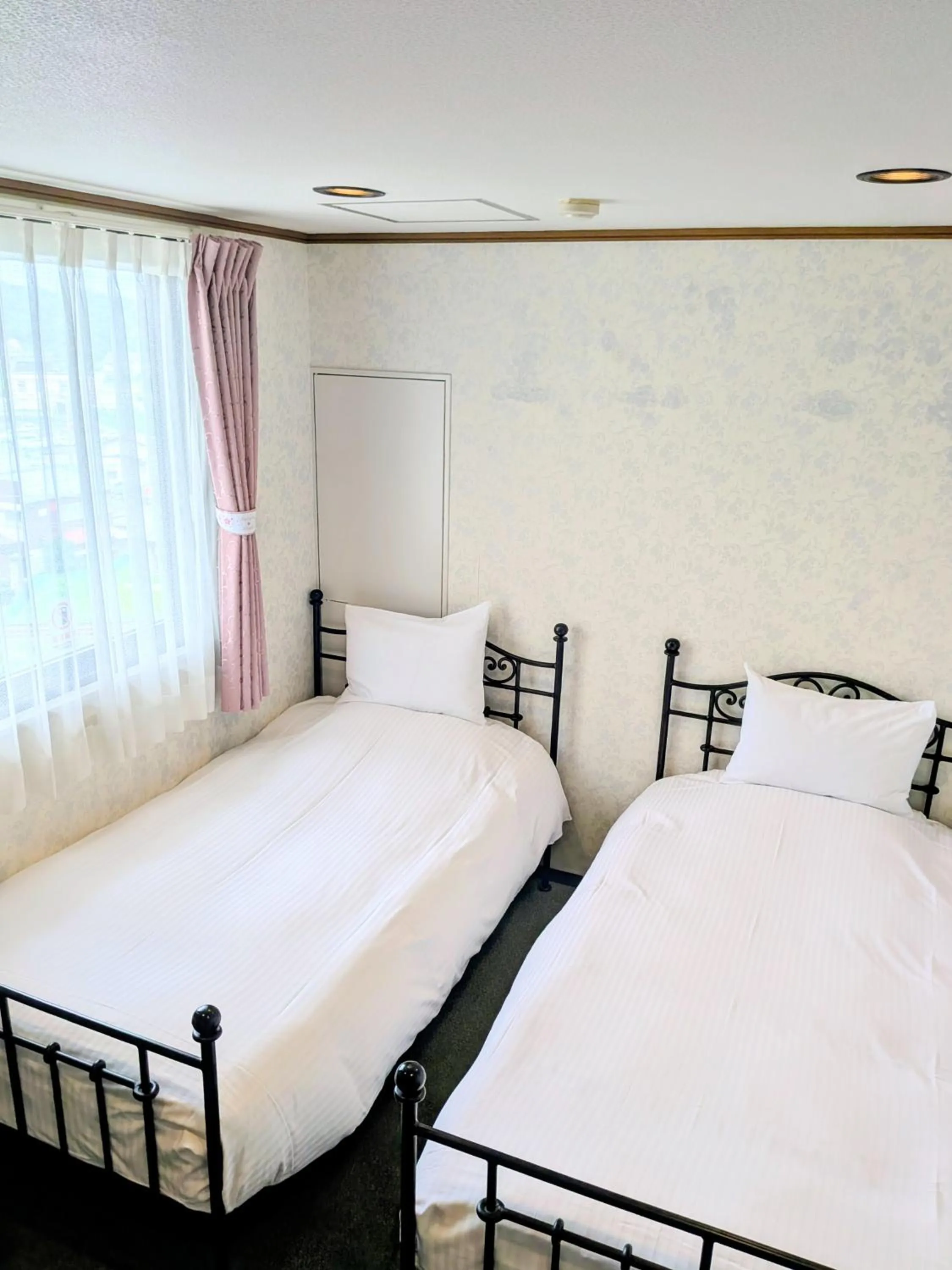 Bed in Sakura Hotel Oami