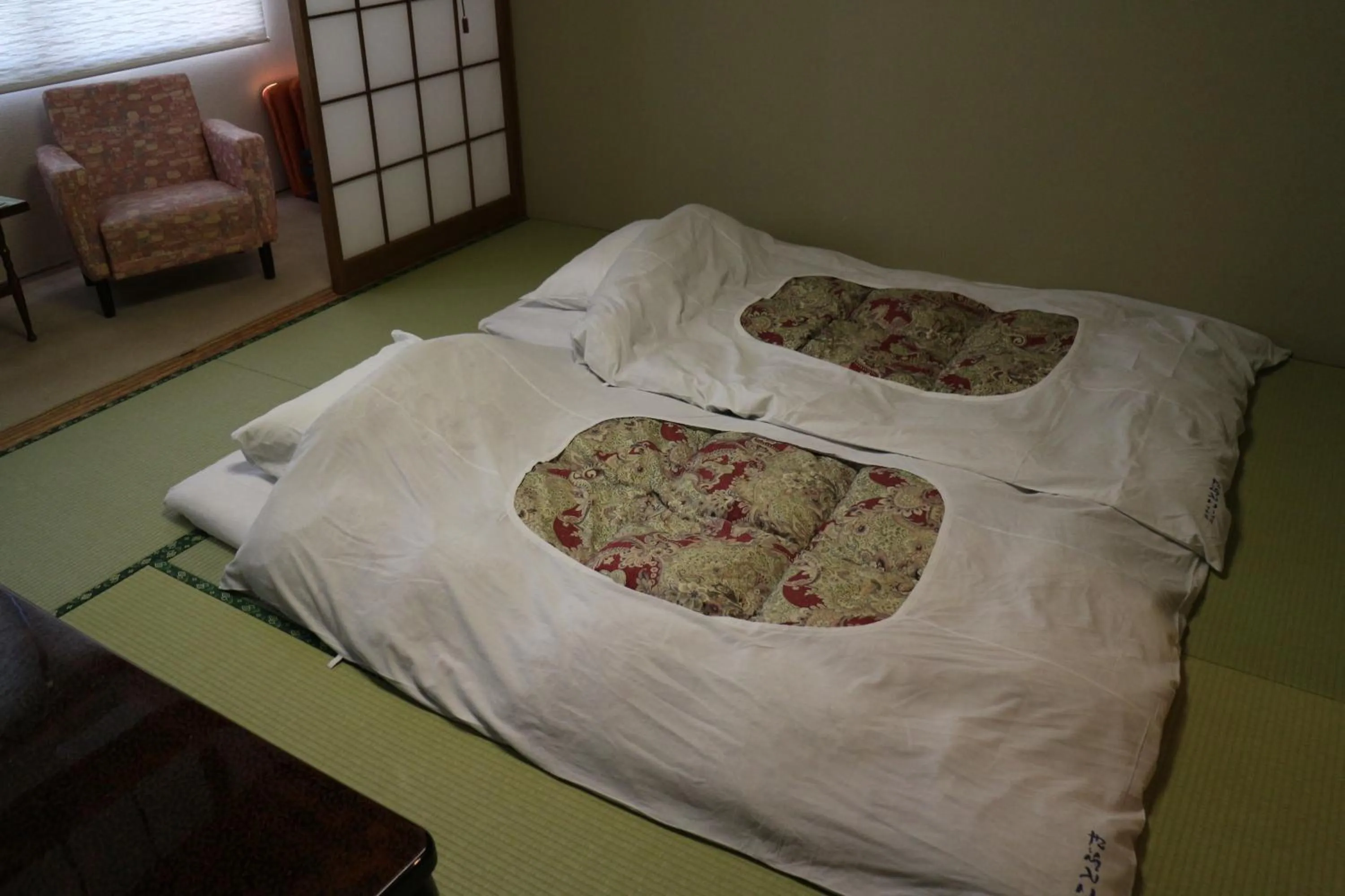 Bed in Hotel New Kotobuki