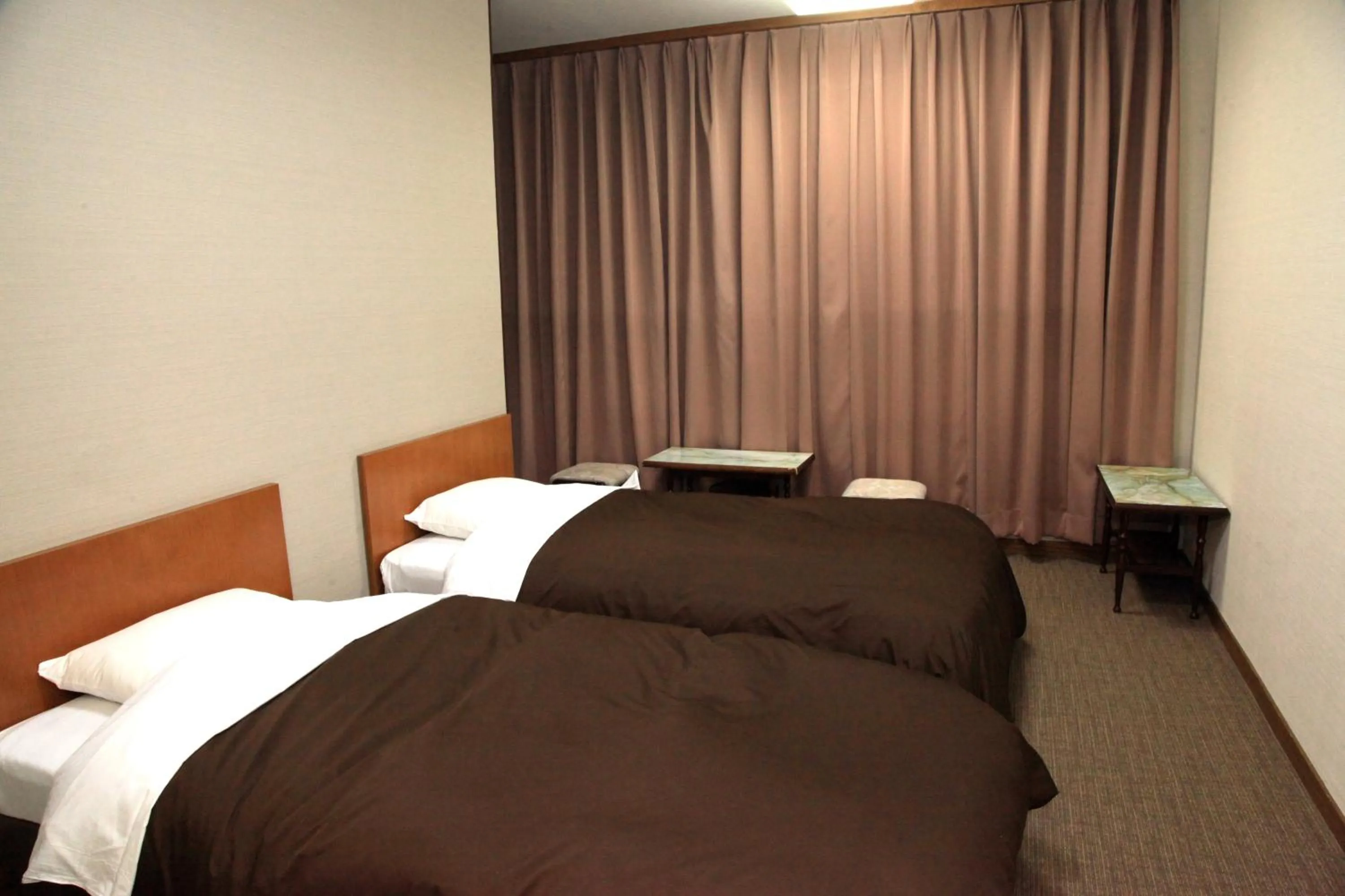 Bed in Hotel New Kotobuki