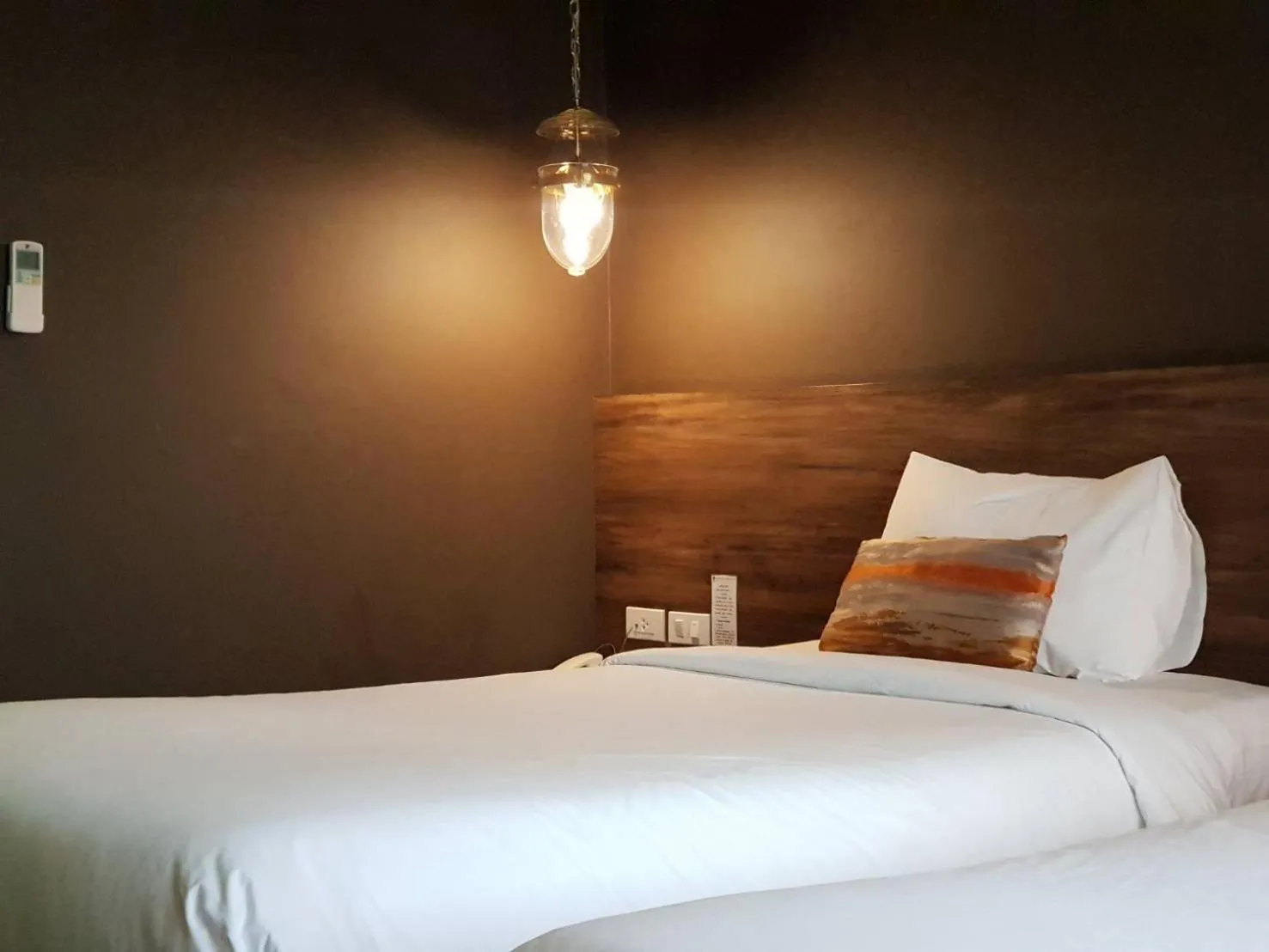 Bed in Chiangkhong Teak Garden Riverfront Onsen Hotel- SHA Extra Plus