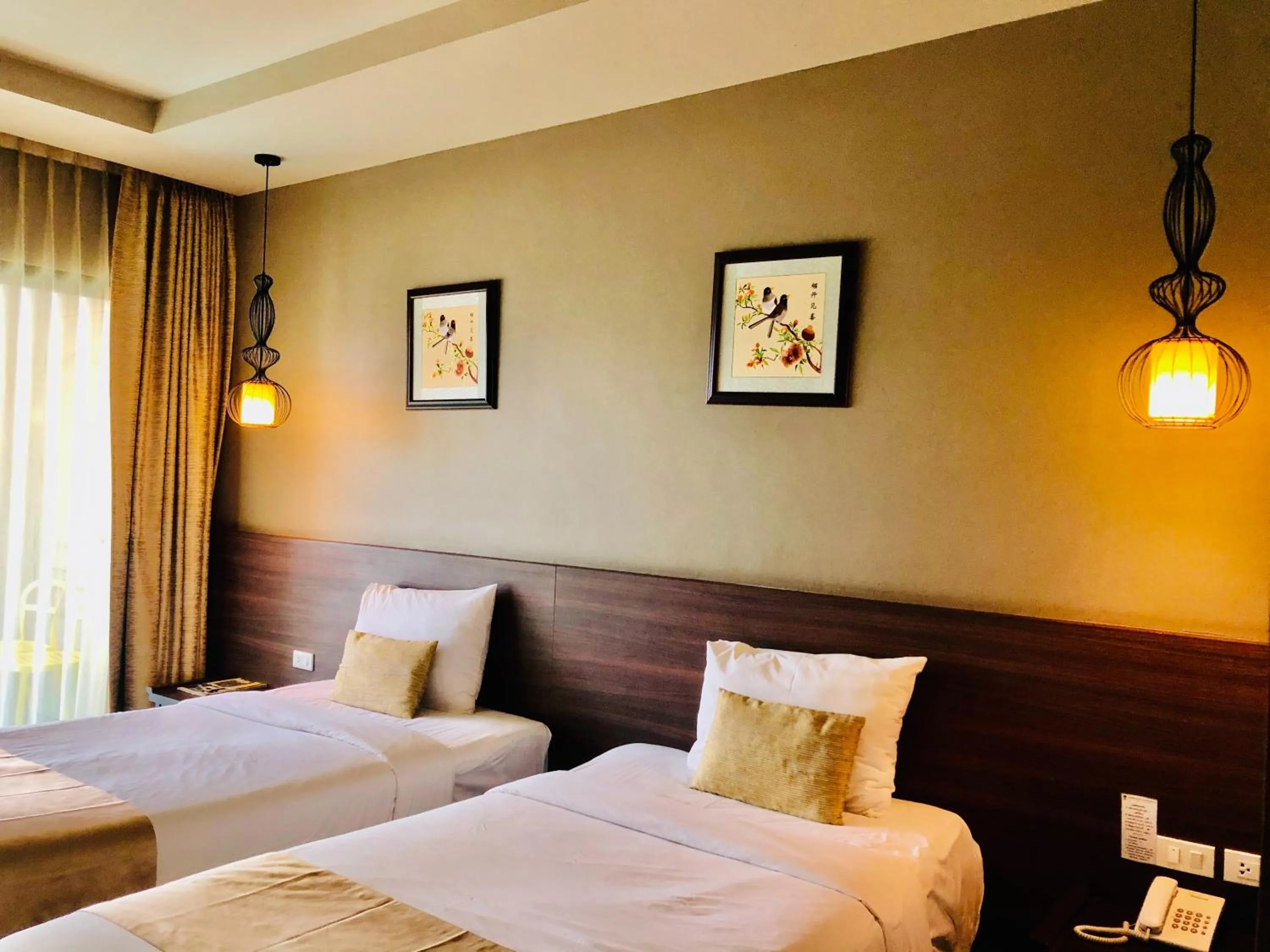 Bed in Chiangkhong Teak Garden Riverfront Onsen Hotel- SHA Extra Plus