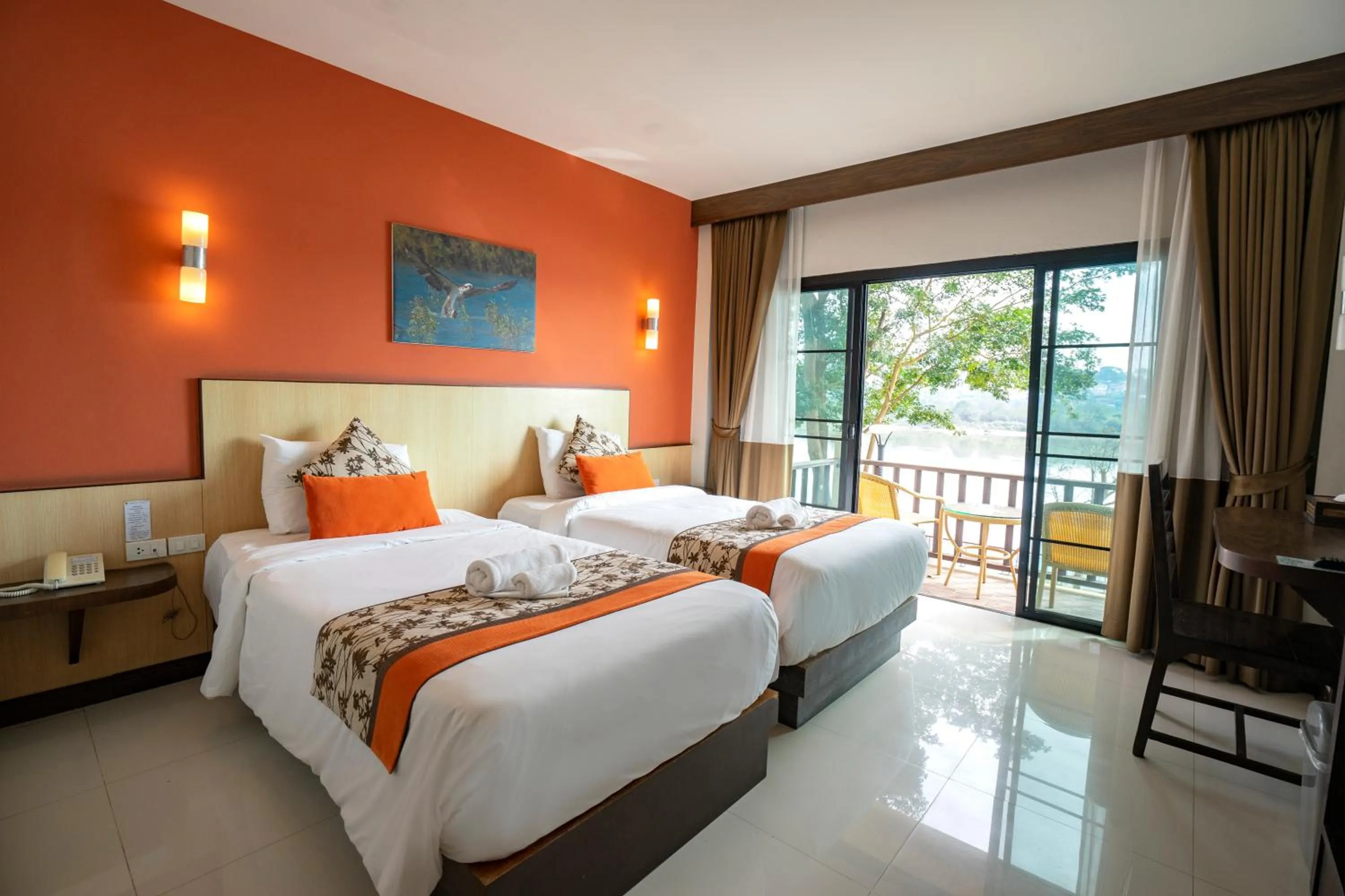 Bed in Chiangkhong Teak Garden Riverfront Onsen Hotel- SHA Extra Plus