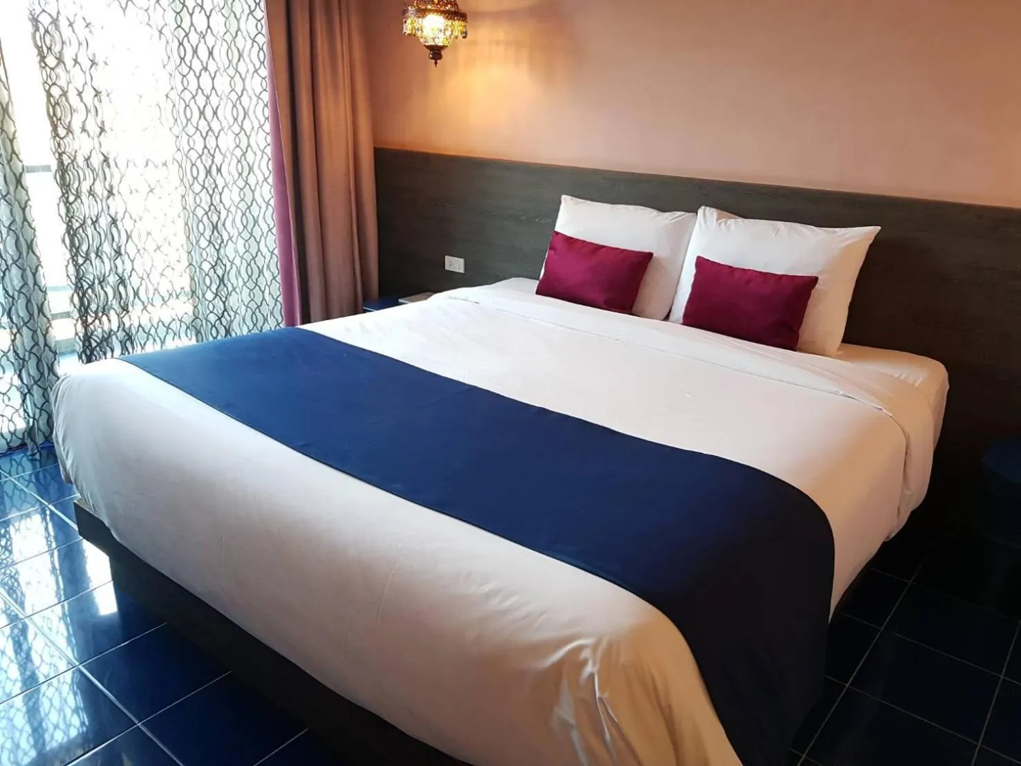 Bed in Chiangkhong Teak Garden Riverfront Onsen Hotel- SHA Extra Plus