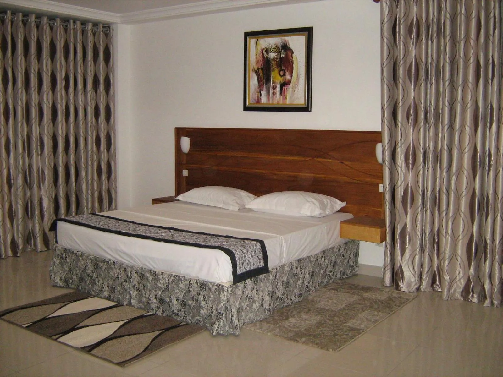 Bed in Rosalie's Suites