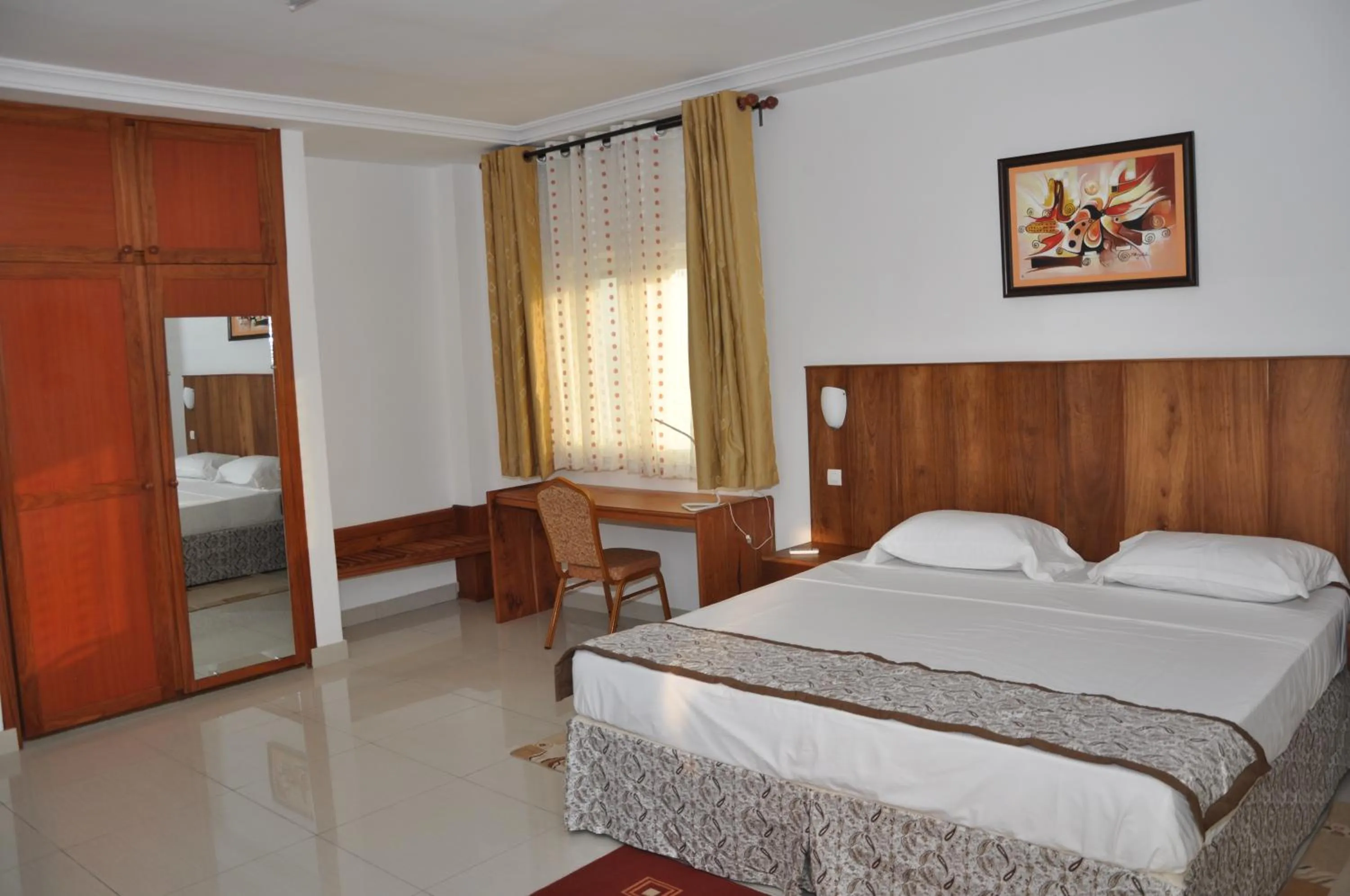 Bed in Rosalie's Suites