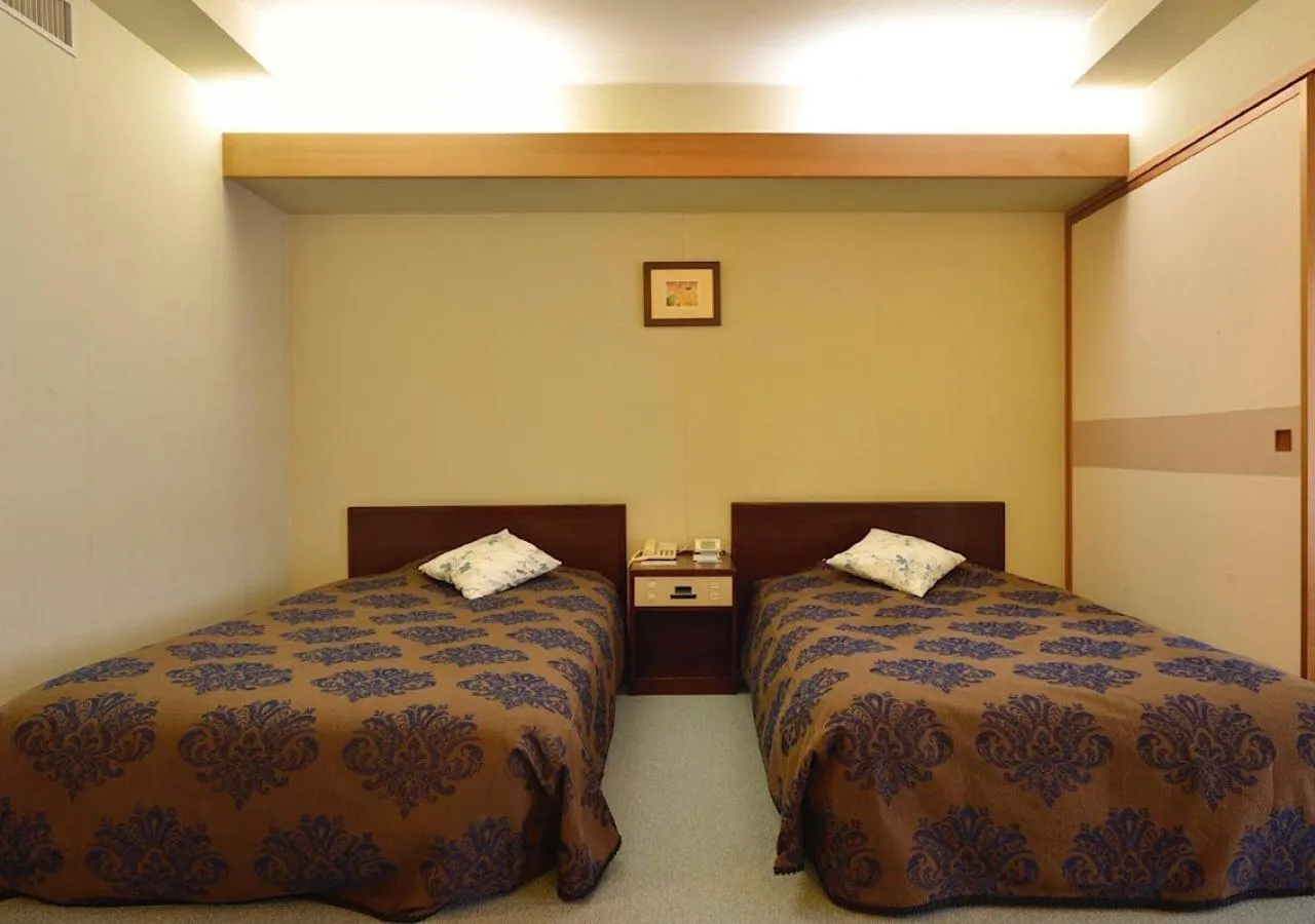 Bed in Mashikokan Satoyama Resort Hotel