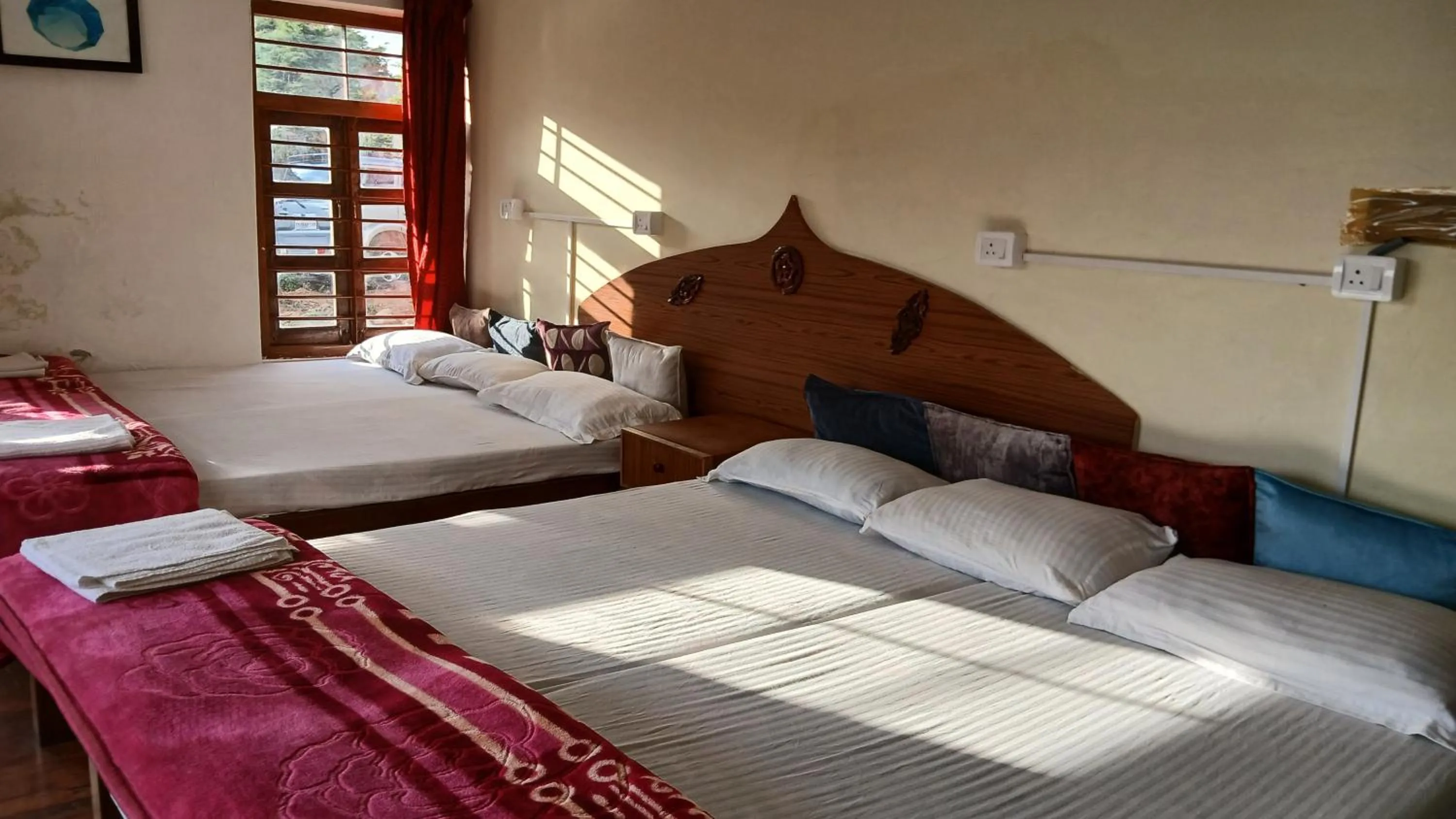 Bed in Satya Anand Cottage Pure Veg and Non Alcoholic Hotel