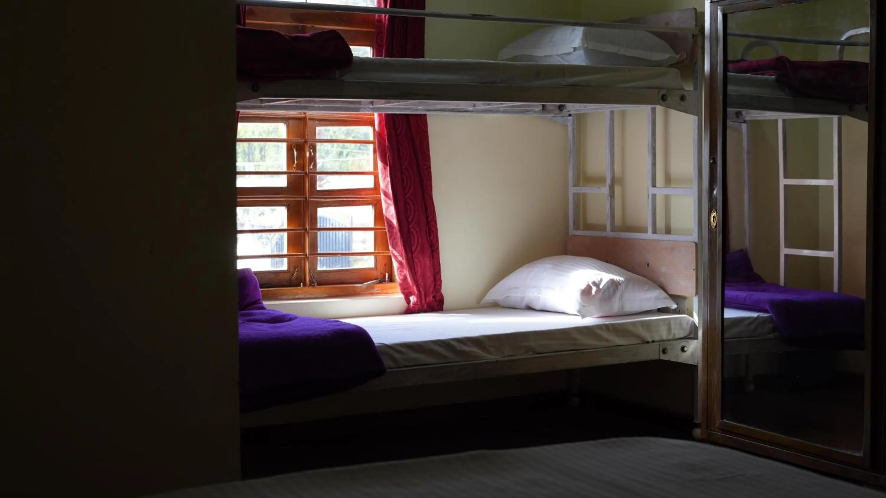 Bed in Satya Anand Cottage Pure Veg and Non Alcoholic Hotel