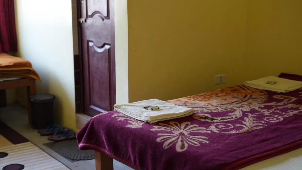 Bed in Satya Anand Cottage Pure Veg and Non Alcoholic Hotel