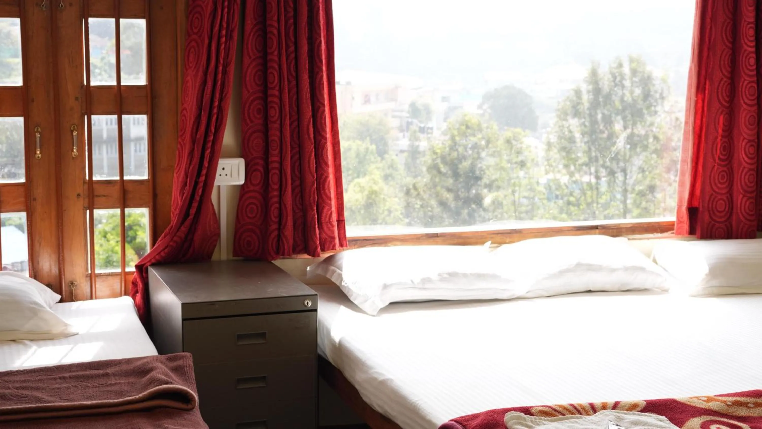 Bed in Satya Anand Cottage Pure Veg and Non Alcoholic Hotel