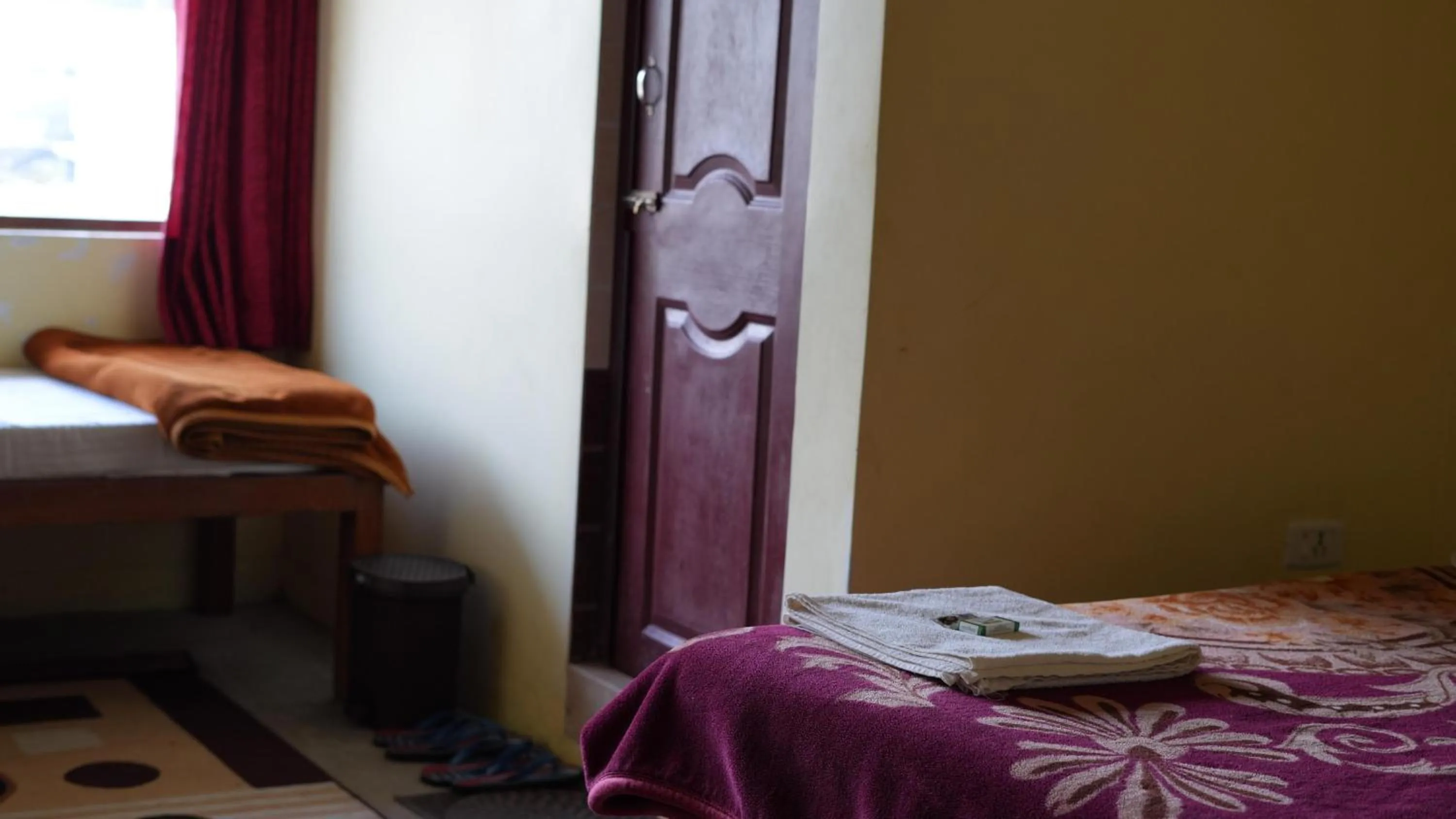 Bed in Satya Anand Cottage Pure Veg and Non Alcoholic Hotel