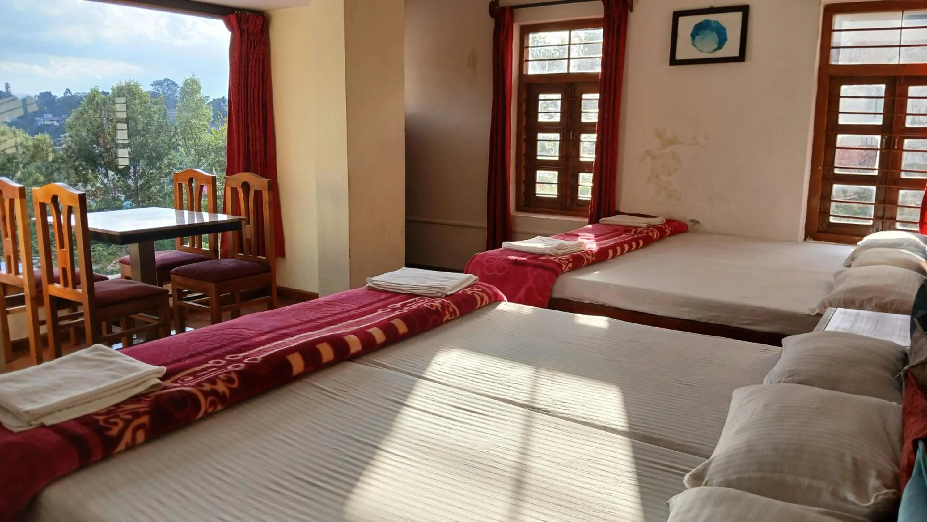 Bed in Satya Anand Cottage Pure Veg and Non Alcoholic Hotel