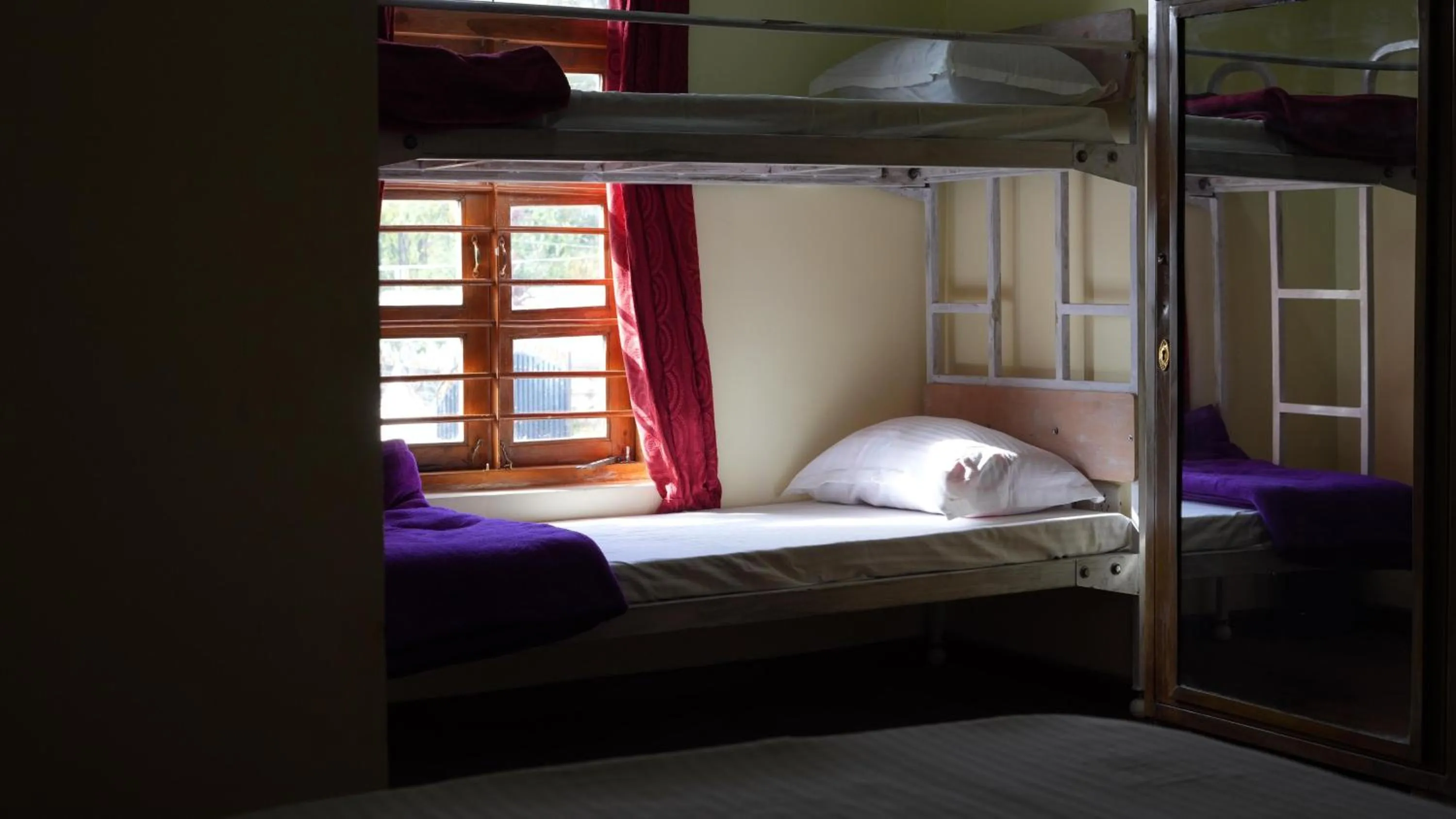 Bed in Satya Anand Cottage Pure Veg and Non Alcoholic Hotel